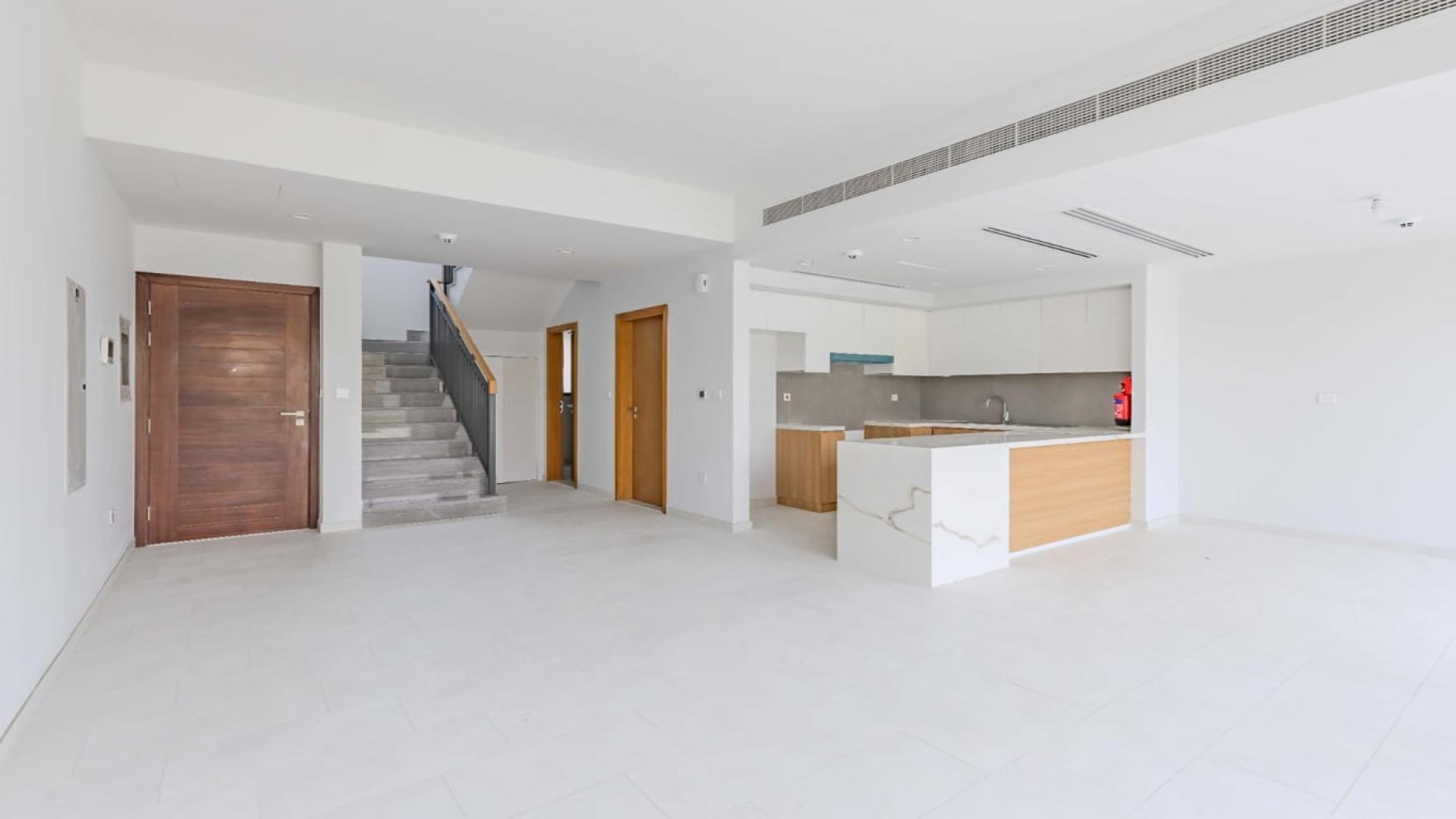 Exterior view of single row 3-bedroom villa in Villanova, Dubai Land with garden