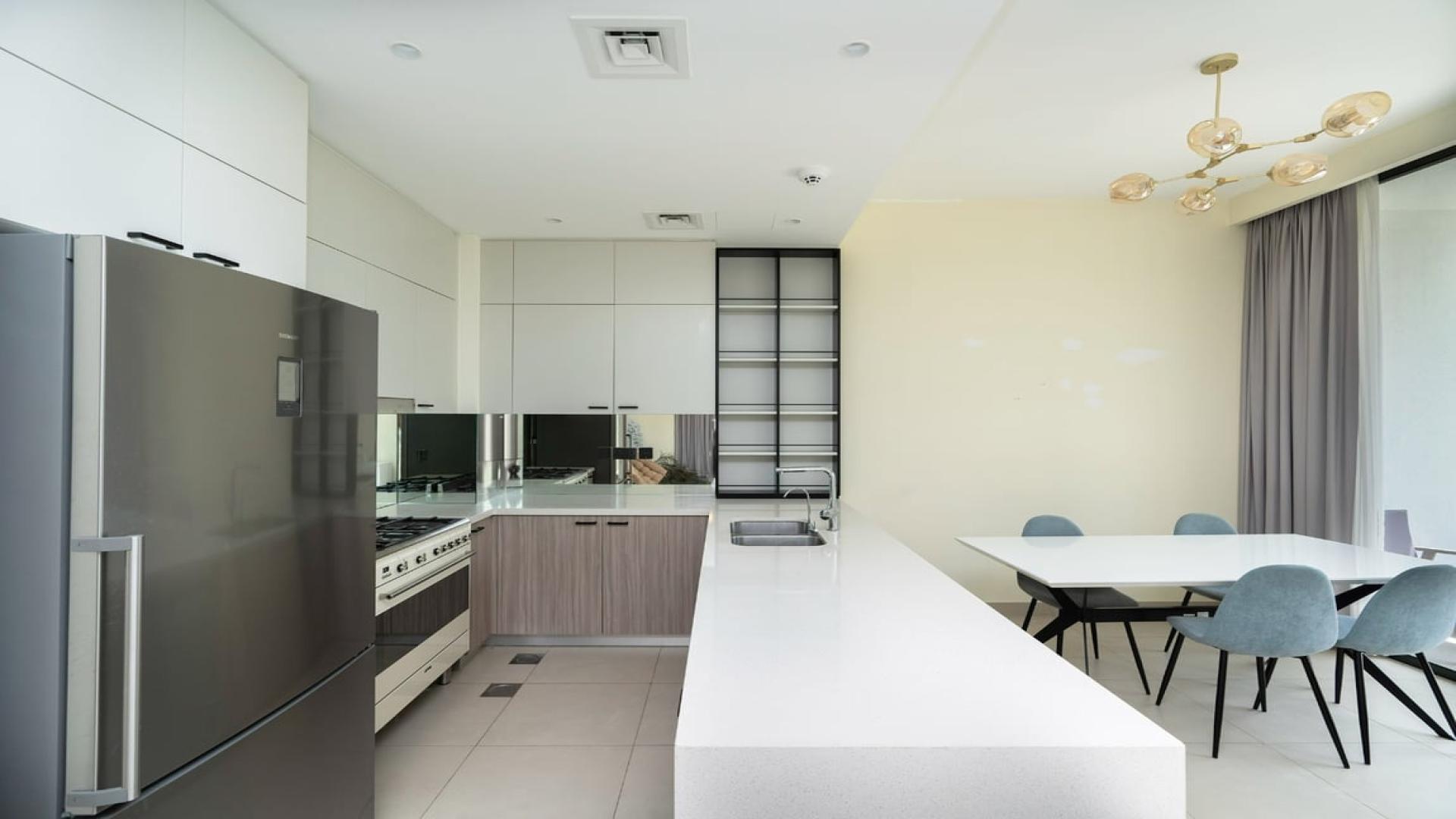 Modern kitchen in 3-bed villa, Golf Grove, Dubai Hills Estate, featuring sleek design and appliances
