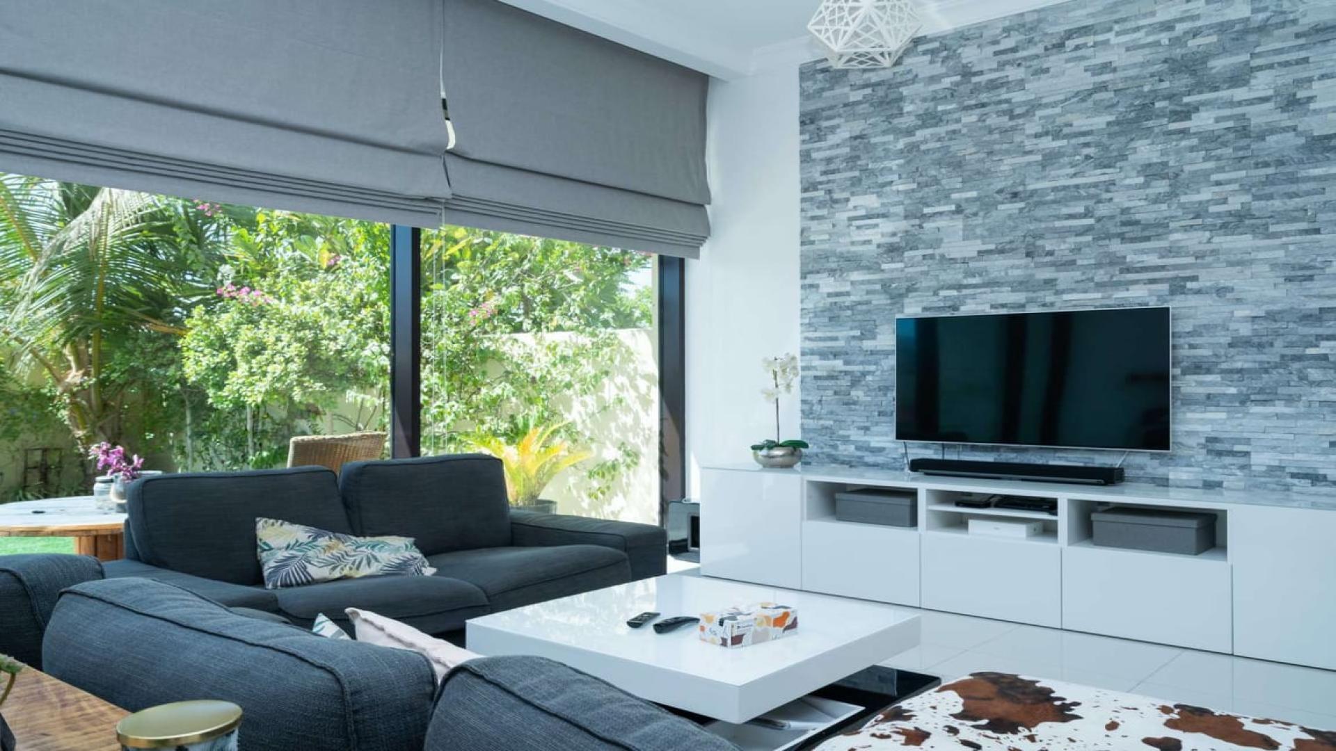 Luxurious living room in furnished villa, Damac Hills, Silver Springs, with modern decor and upgrades