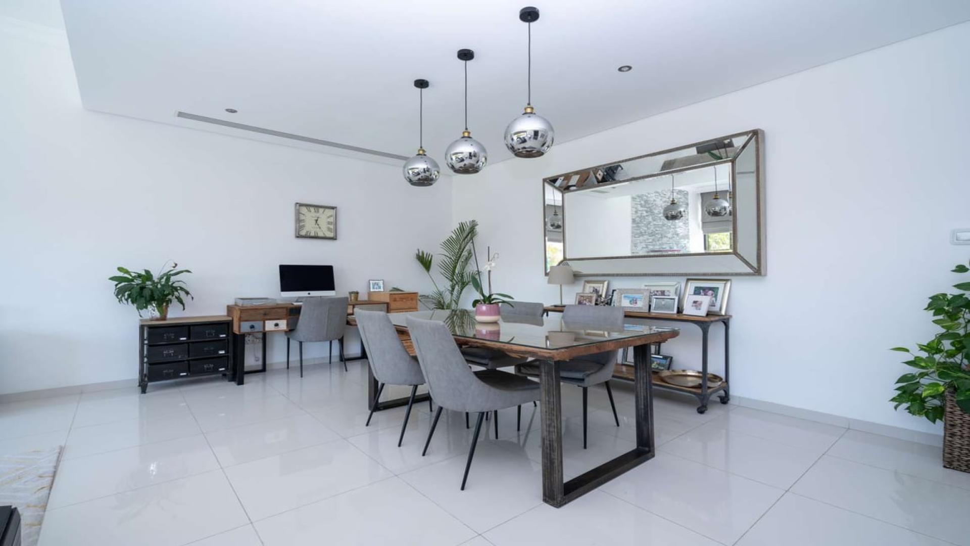 Modern living and dining area in upgraded Silver Springs villa, Damac Hills, for sale
