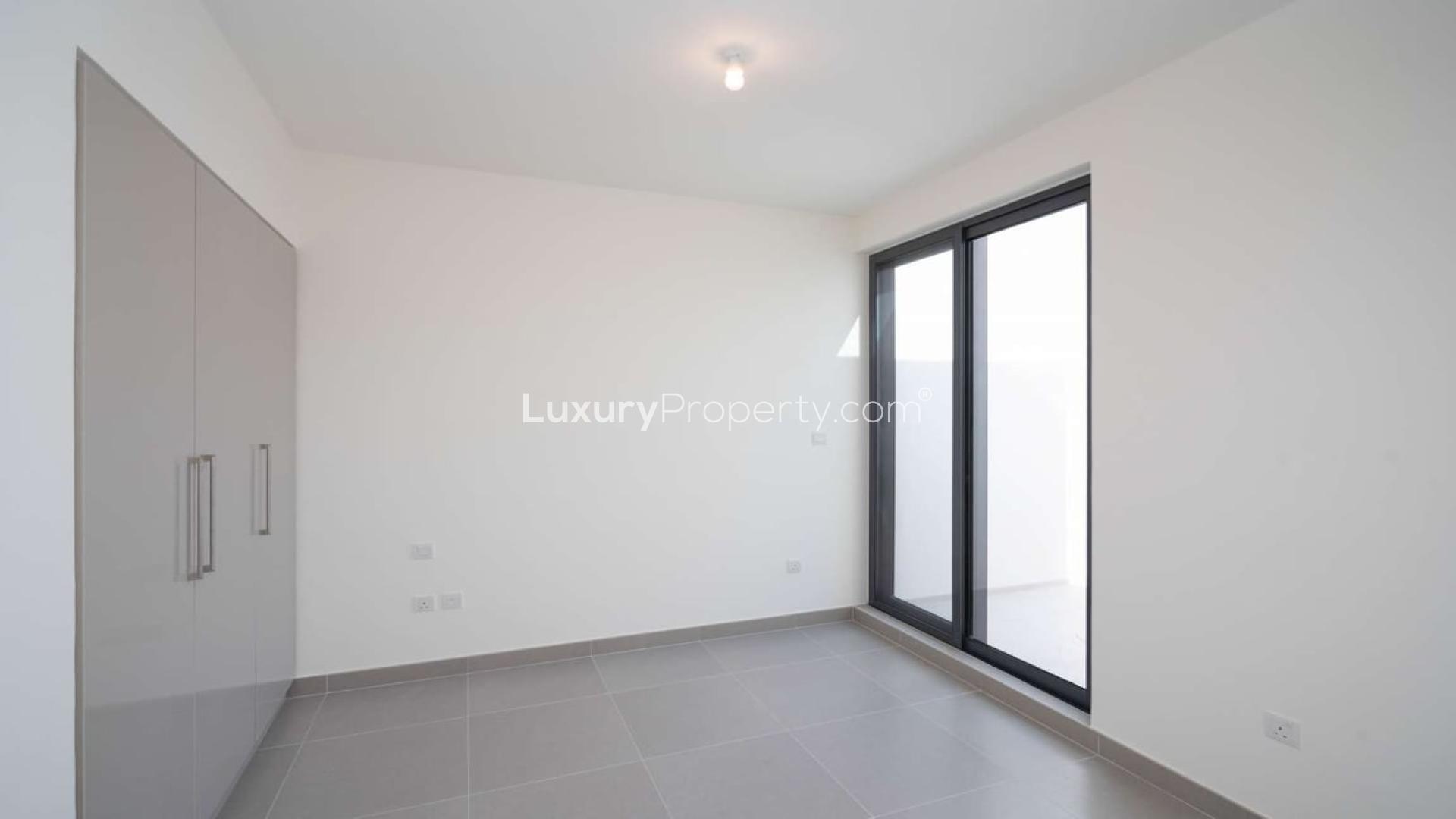 Empty bedroom with large window and built-in wardrobe in Dubai Hills Estate townhouse