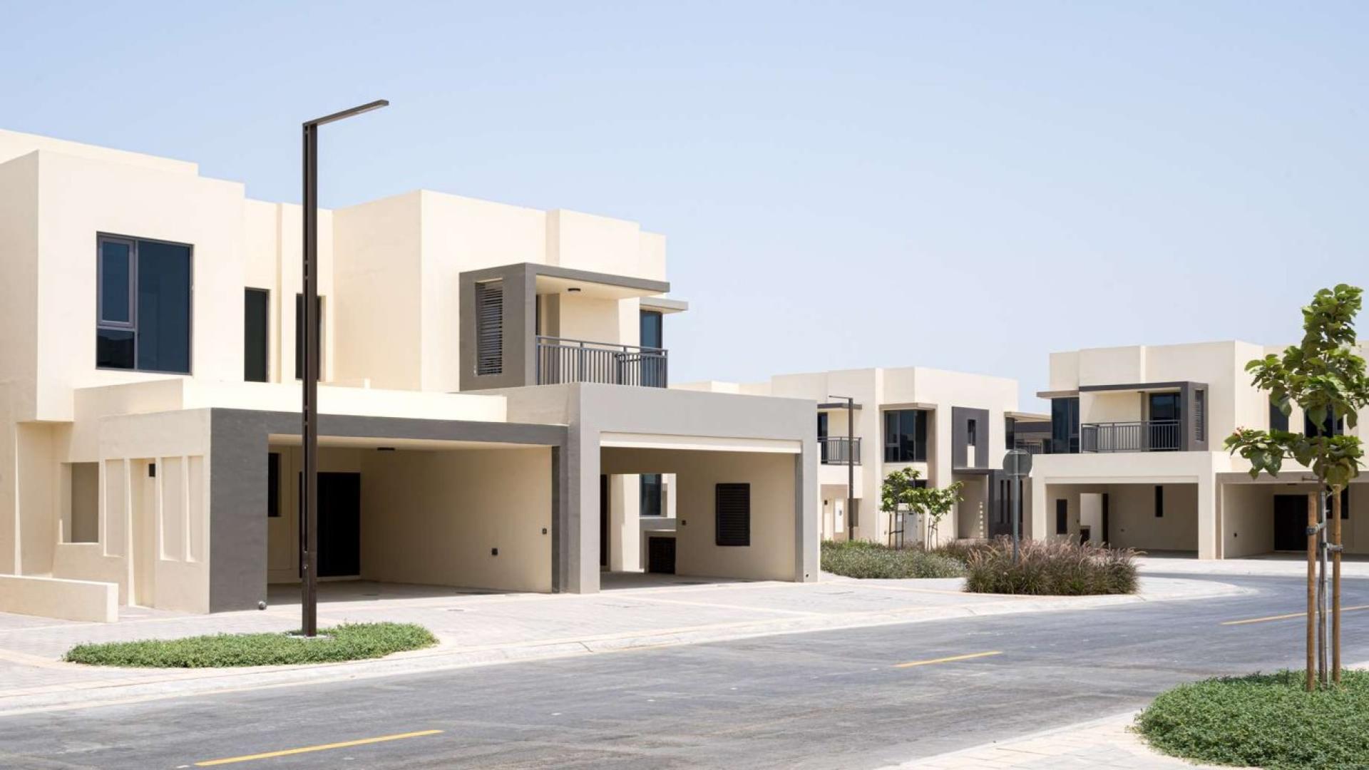 Modern single row townhouse exterior in Maple at Dubai Hills Estate, featuring two-car garage