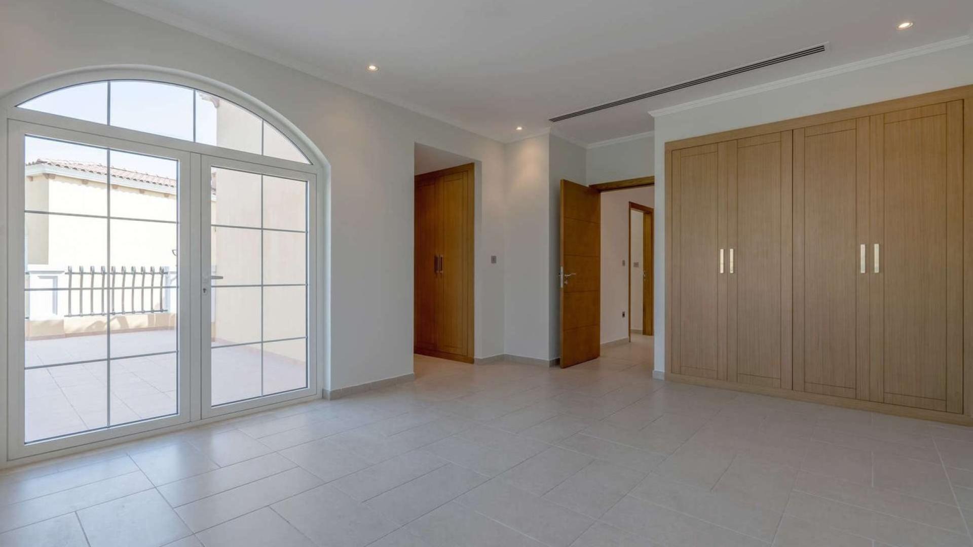 Modern kitchen in large Legacy style villa, Jumeirah Park, featuring wood cabinets and countertops
