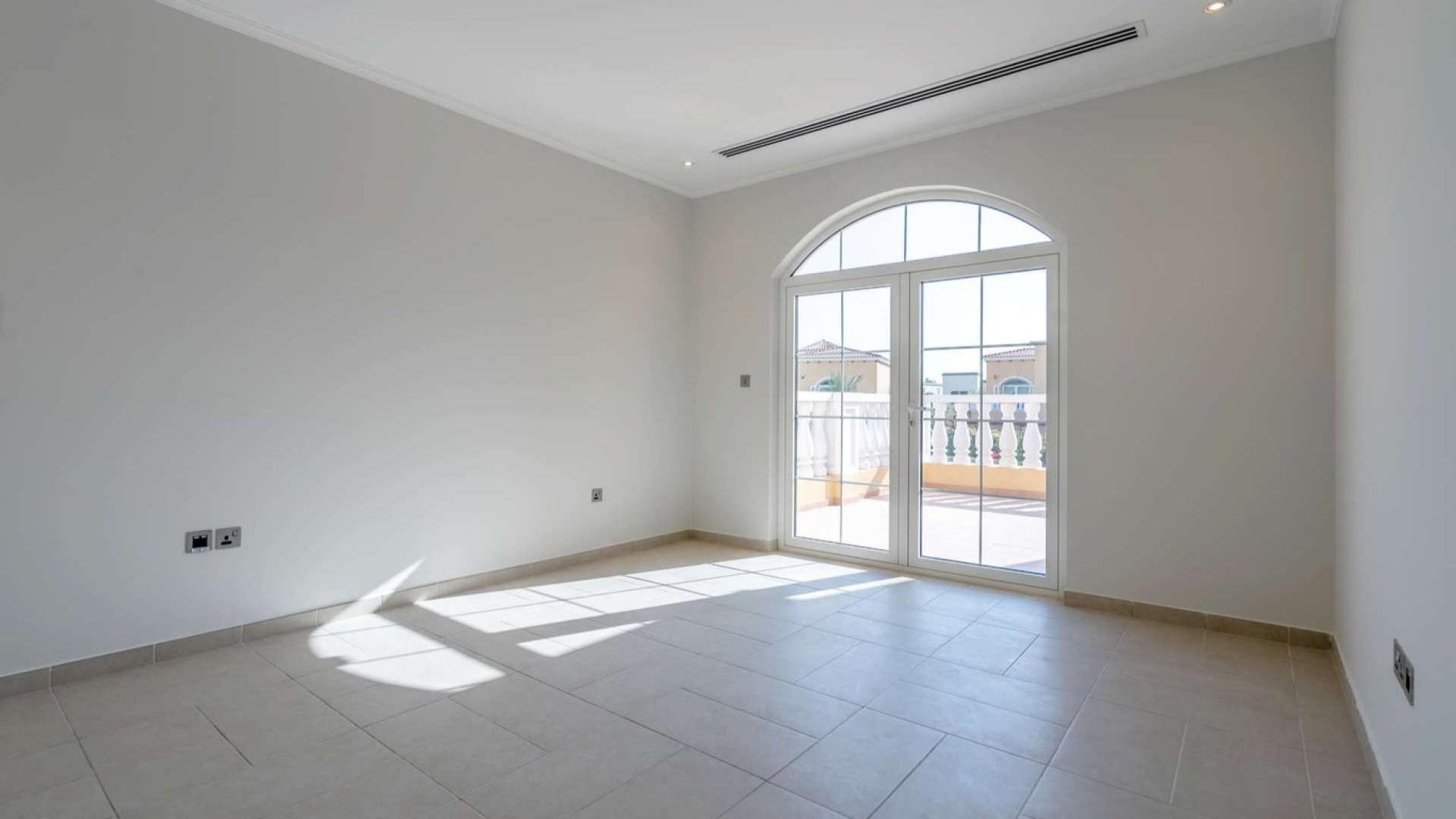 Spacious living room in Legacy style villa, Jumeirah Park, with large windows and garden view