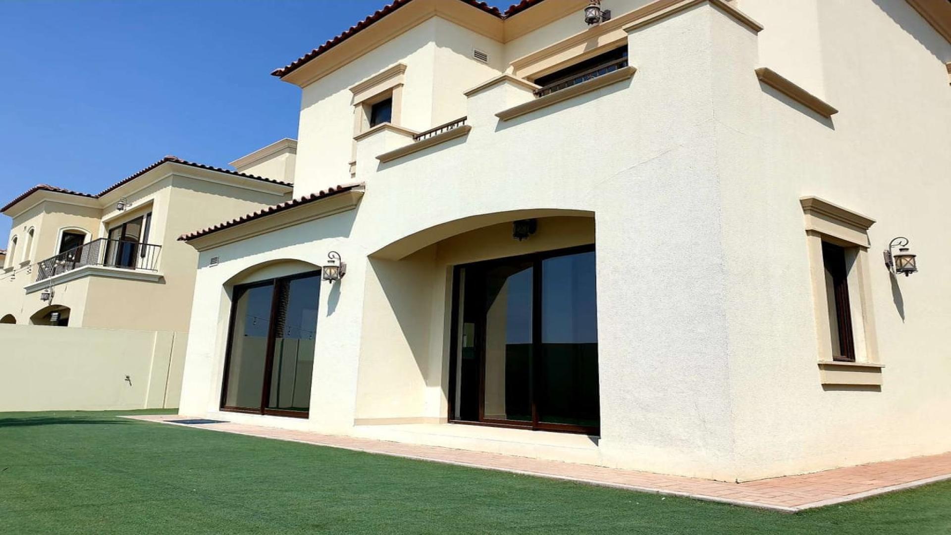 Exterior view of Samara villa in Arabian Ranches 2, featuring spacious lawn and patio