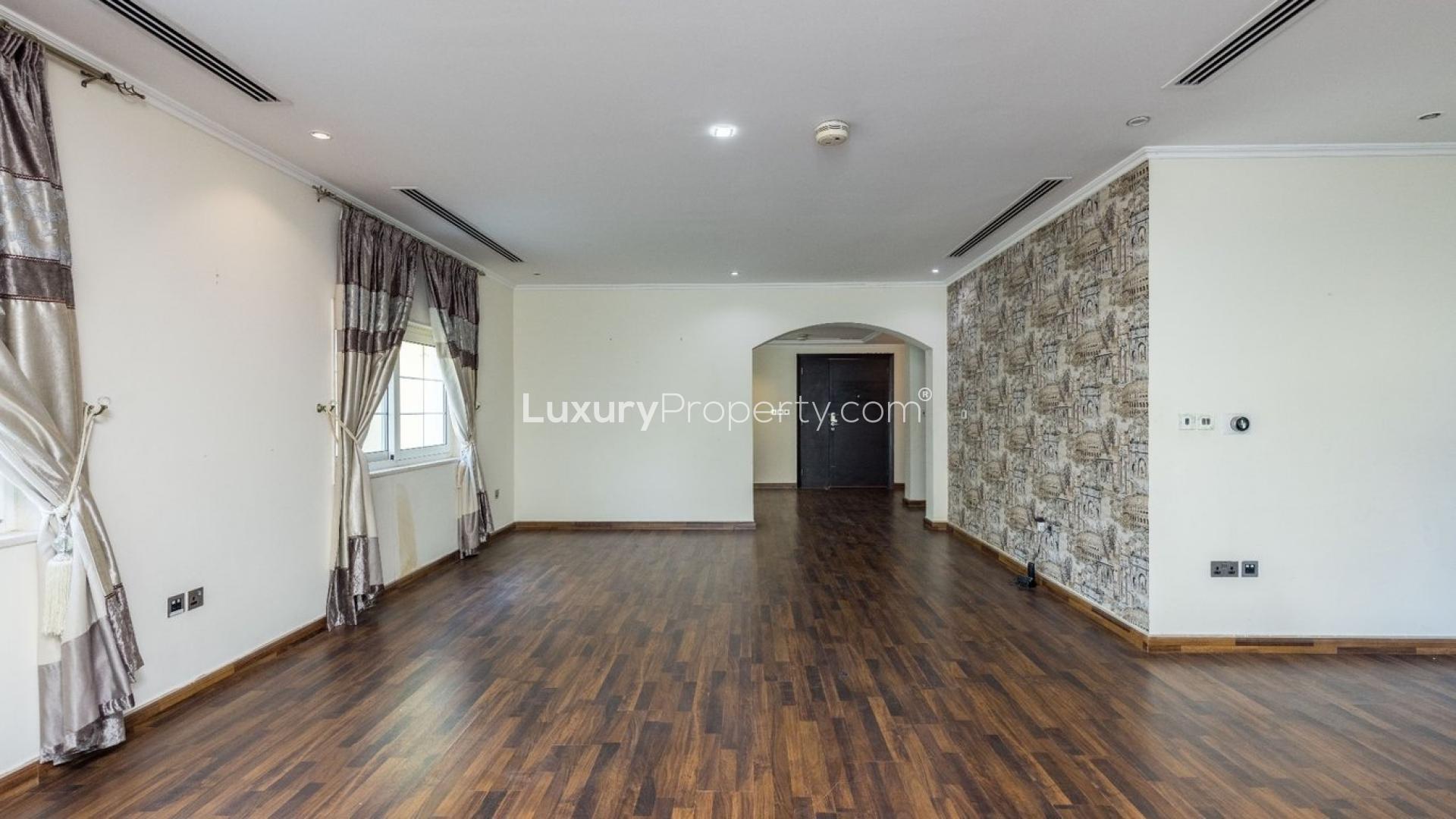 Spacious living room in three-bedroom Legacy Villa, Jumeirah Park, featuring elegant wood flooring