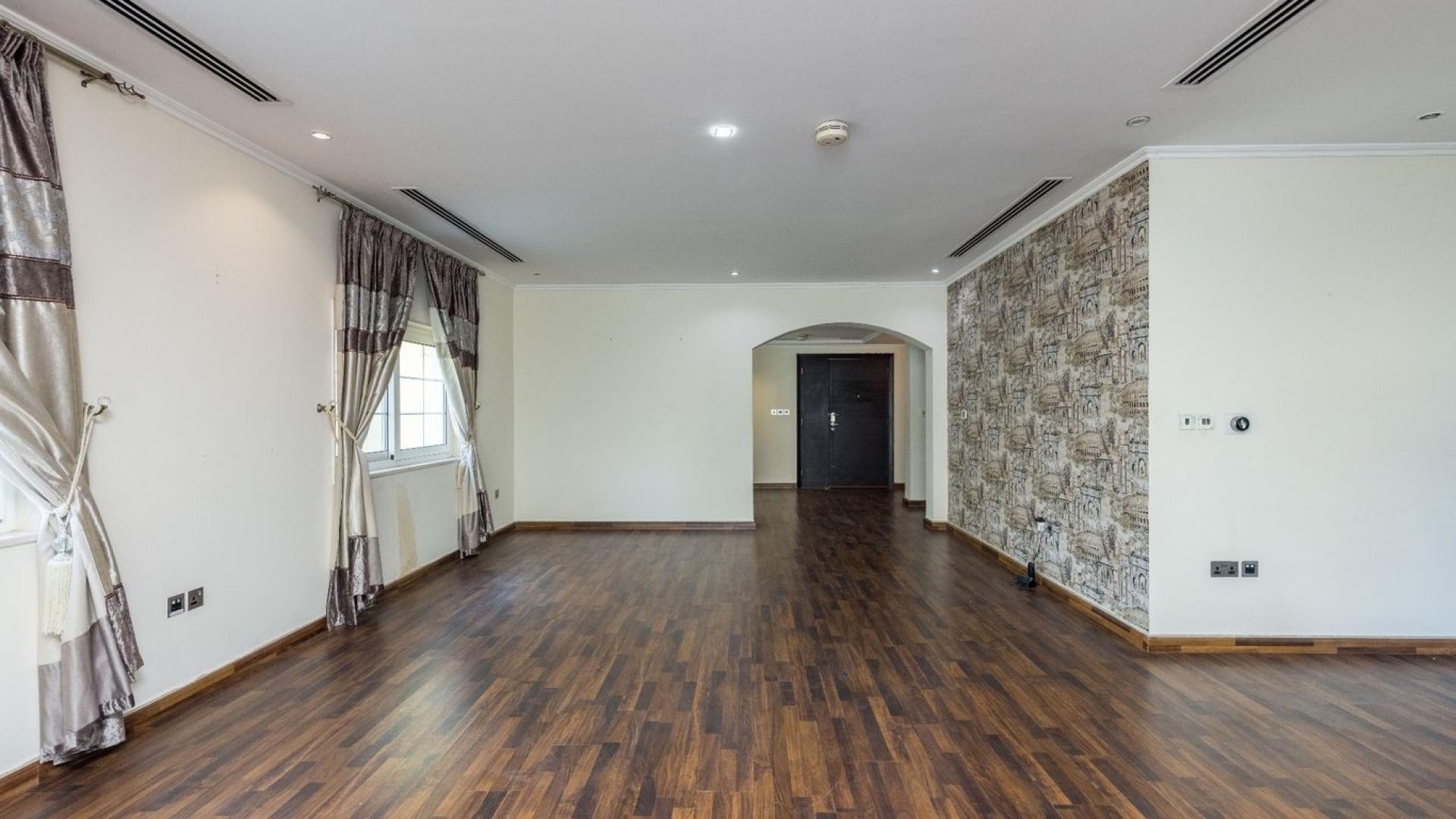 Spacious living room in three-bedroom Legacy Villa, Jumeirah Park, featuring elegant wood flooring