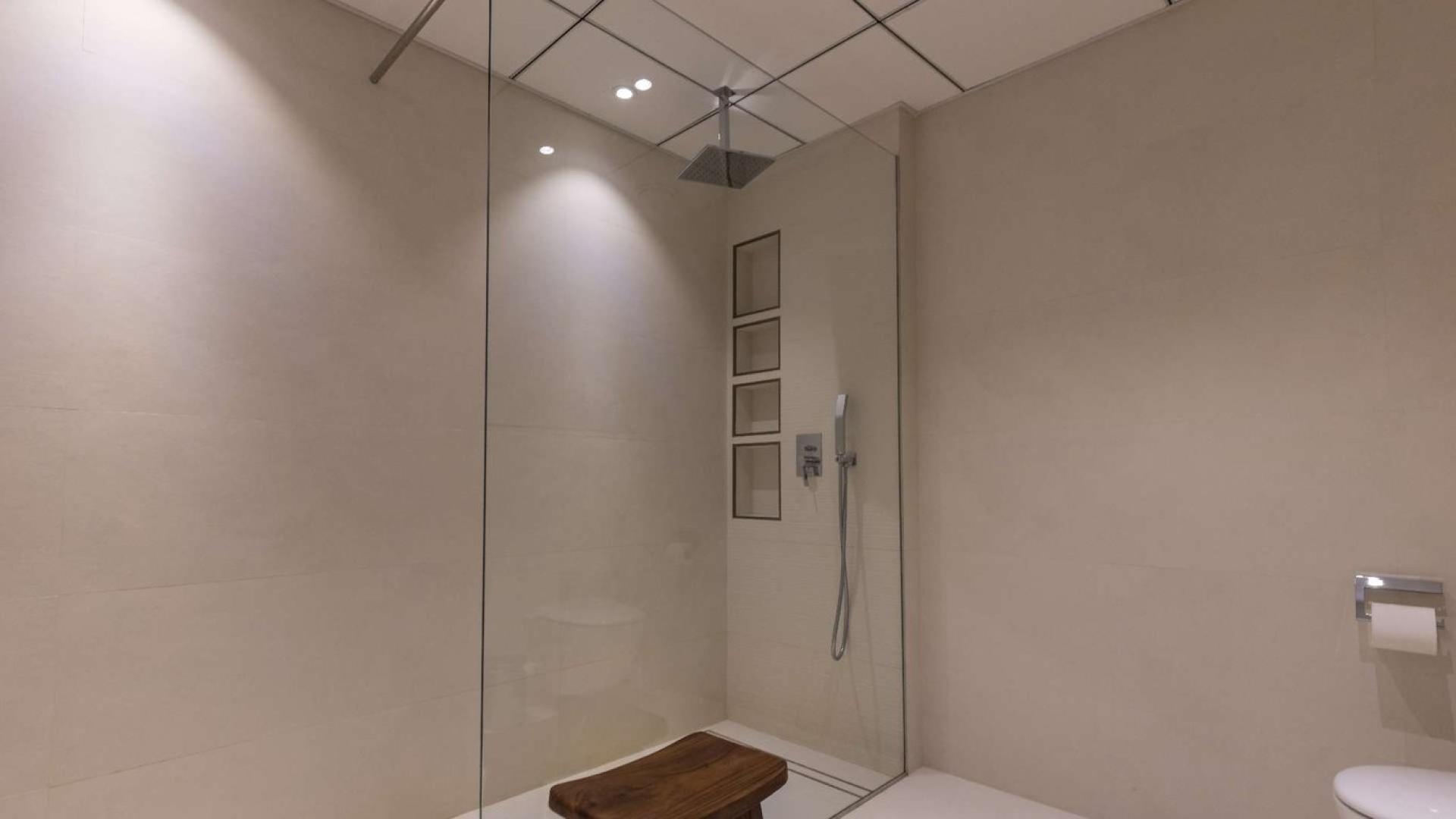 "Spacious living area in Al Sahab 1 villa, Dubai Marina, featuring modern decor and hardwood floors.",Modern bathroom with glass shower in Al Sahab 1 villa, Dubai Marina