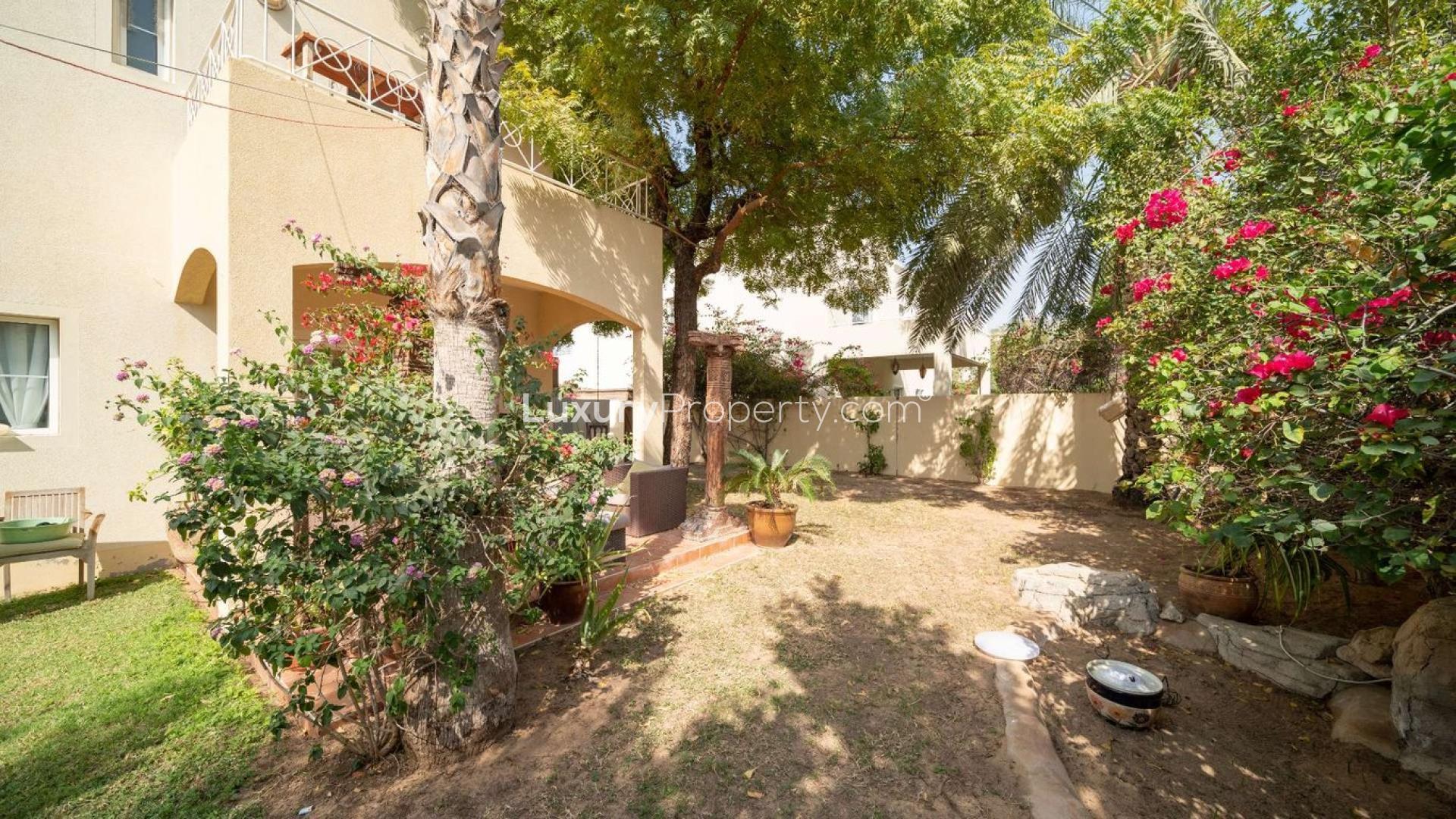 "Charming villa garden and patio in Meadows 1, ideal for relaxation and outdoor activities.",Lush garden view of Meadows 1 villa for sale, surrounded by greenery and flowers