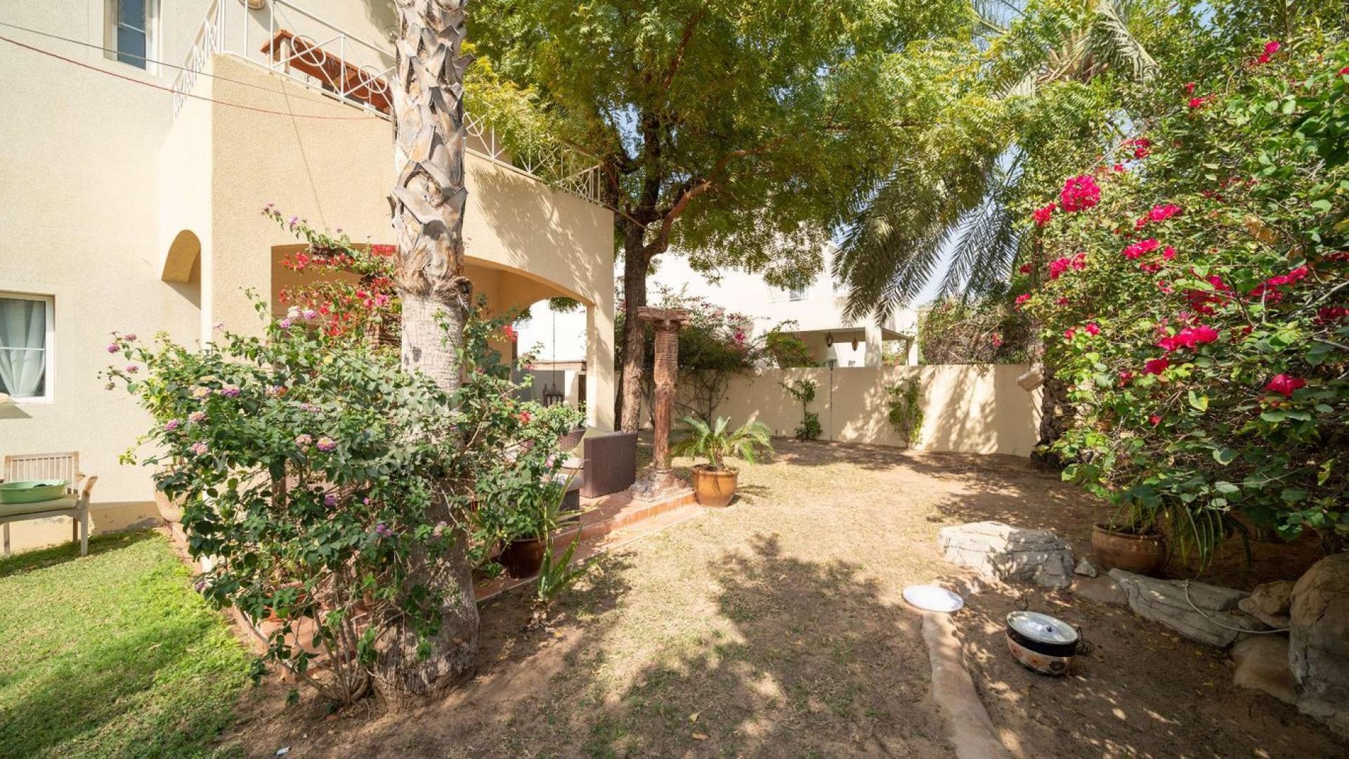 "Charming villa garden and patio in Meadows 1, ideal for relaxation and outdoor activities.",Lush garden view of Meadows 1 villa for sale, surrounded by greenery and flowers