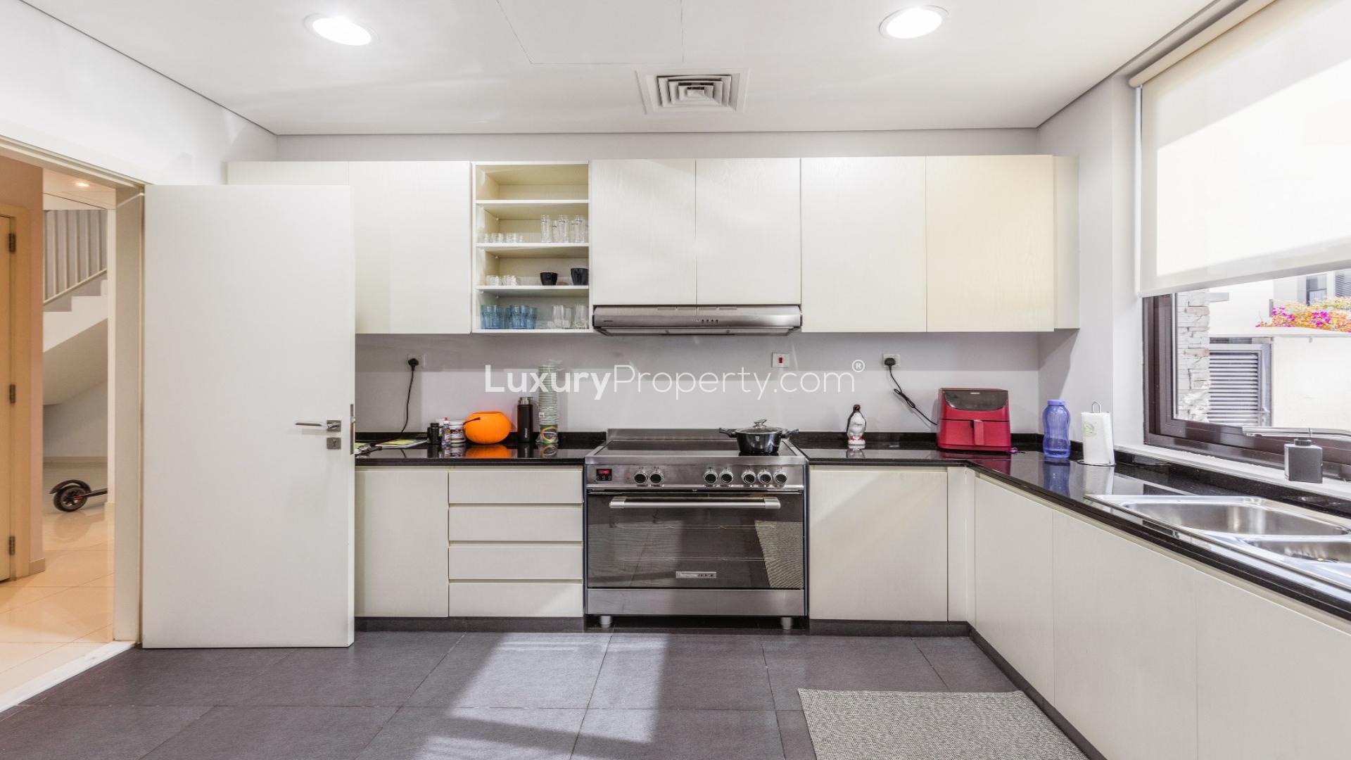 Modern kitchen in upgraded single-row villa, The Field, Damac Hills. Spacious with natural light