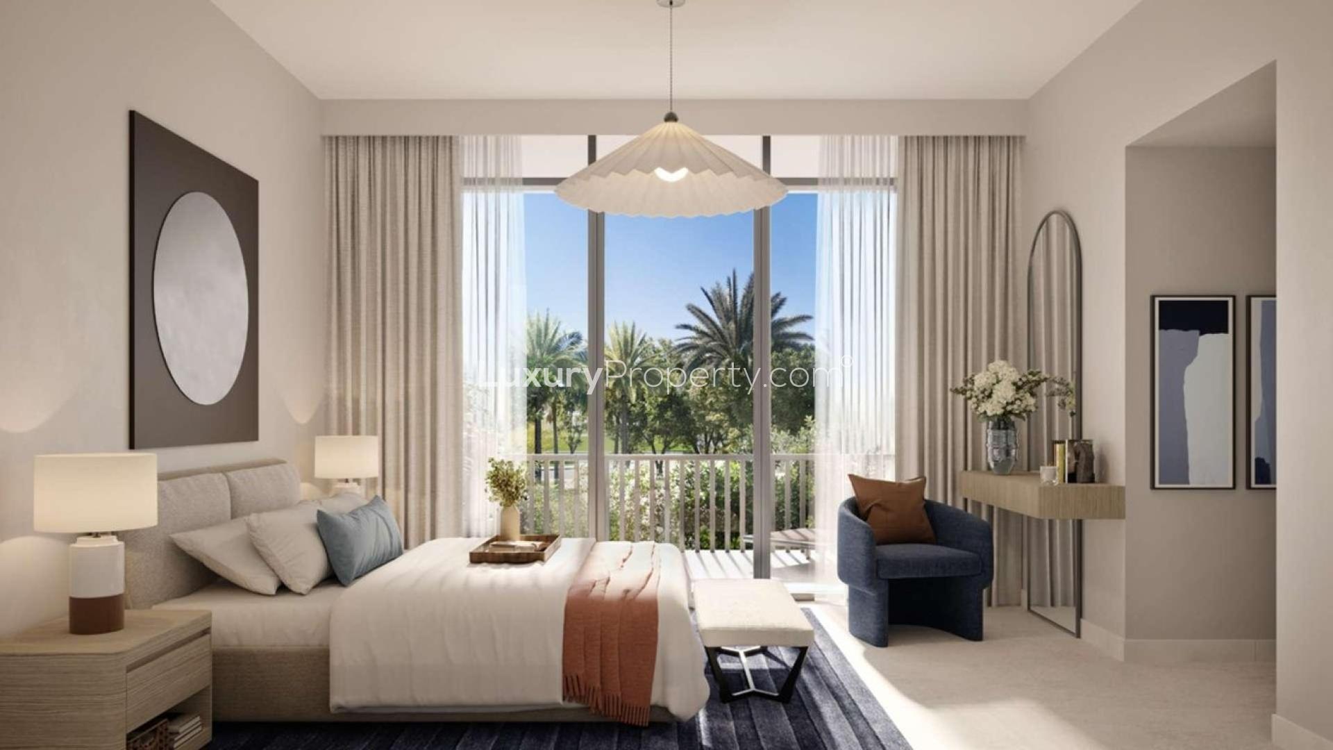 Modern living room in Arabian Ranches 3 villa, featuring open kitchen and garden views