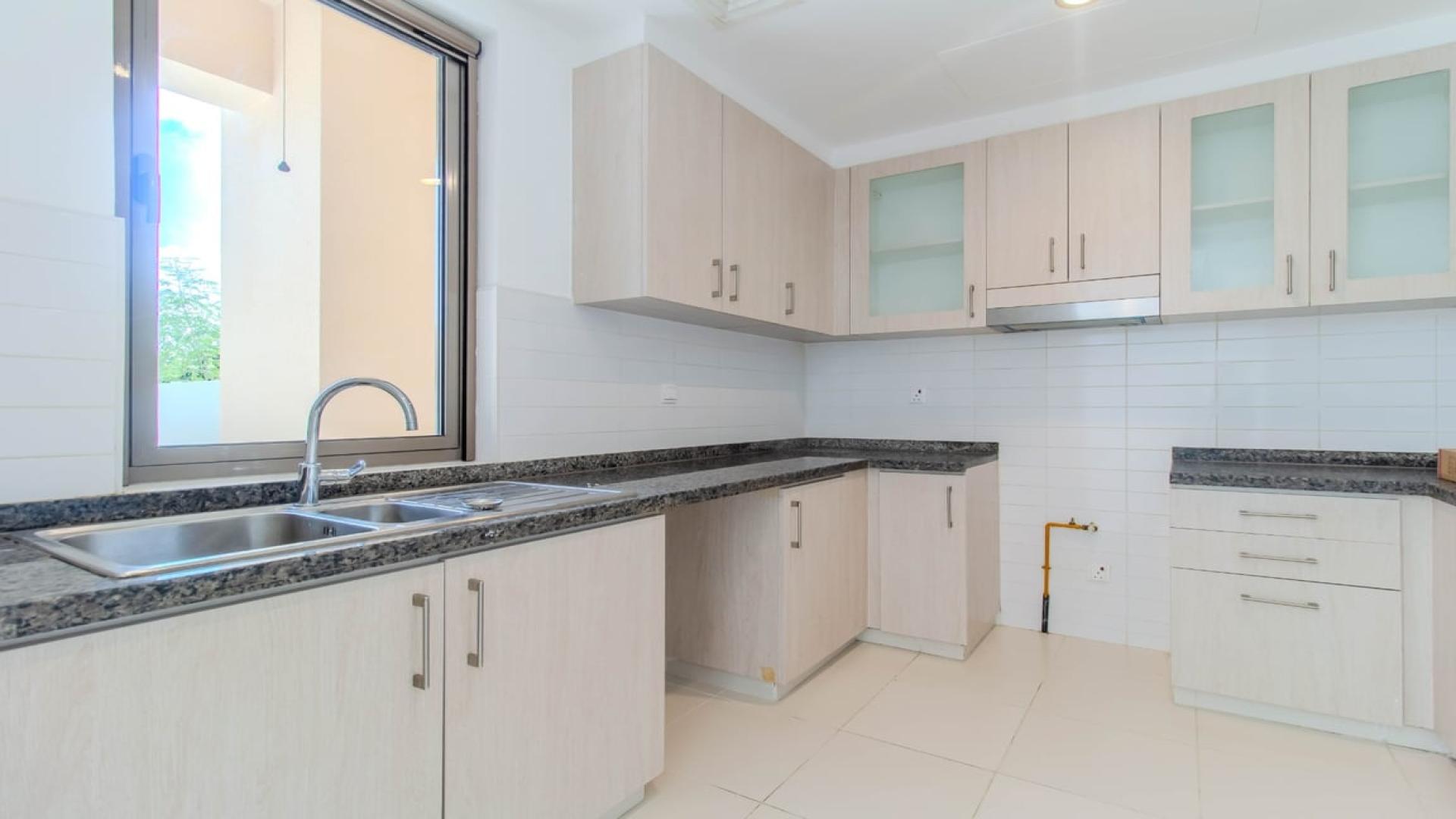 Modern kitchen in Mira Oasis villa, featuring sleek countertops and ample cabinetry