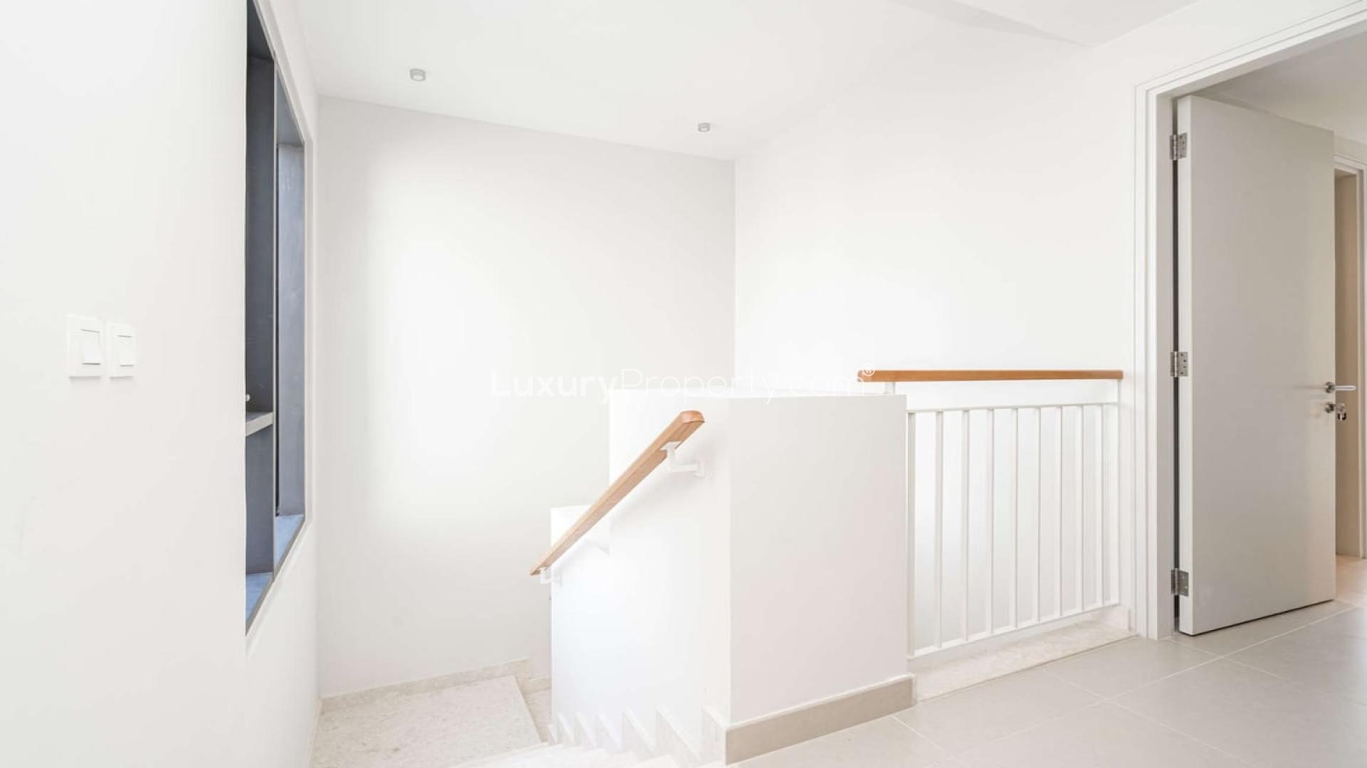 Modern kitchen in Maple villa, Dubai Hills Estate, featuring sleek white cabinetry and countertops