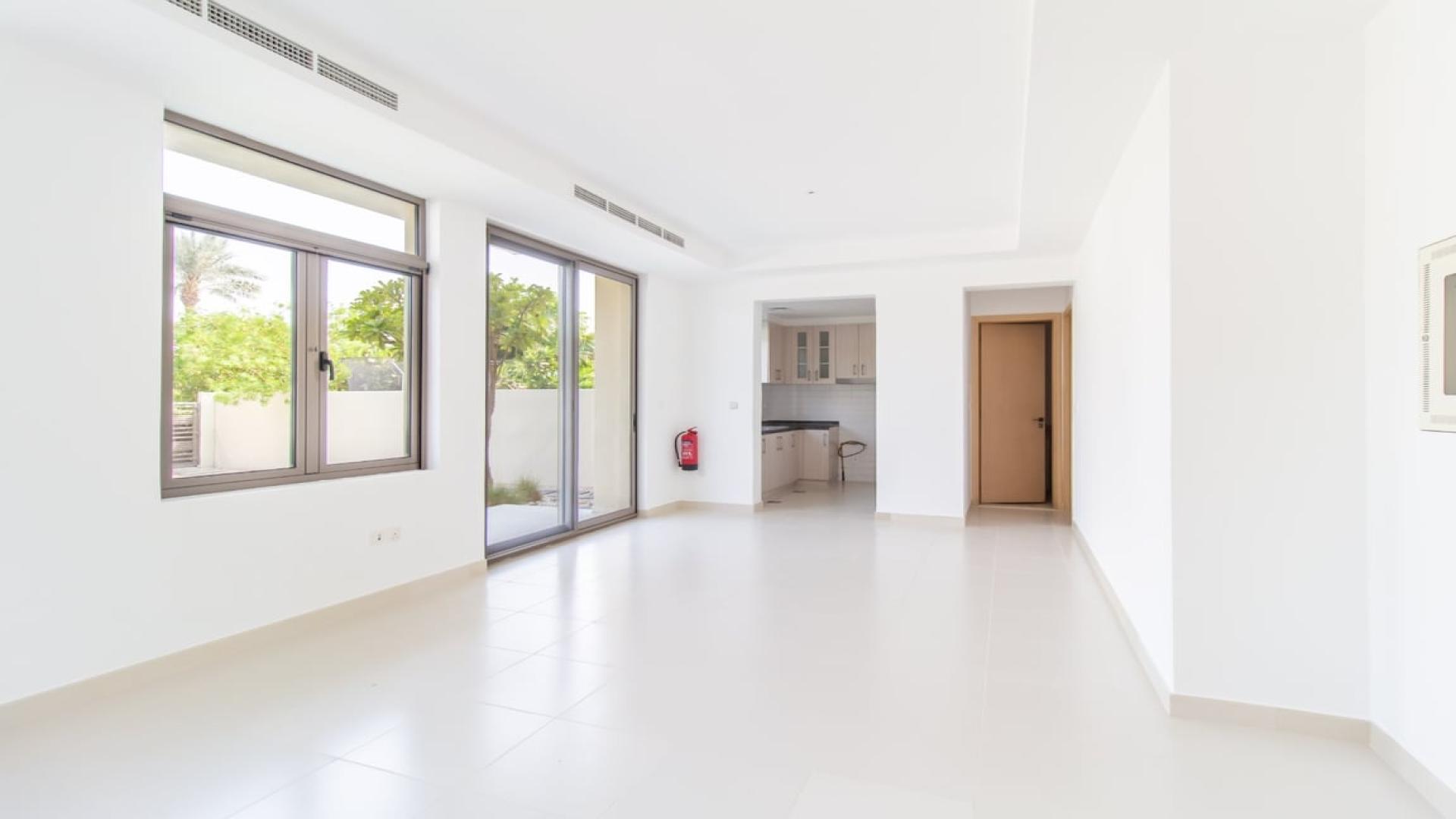 "Elegant 3-bedroom villa exterior with lawn in Mira Oasis, Dubai, for sale.","Spacious living area in 3-bedroom villa, Mira Oasis, Reem, Dubai, for sale.",Modern kitchen in elegant 3-bedroom villa, Mira Oasis, Dubai, featuring sleek cabinetry and countertops