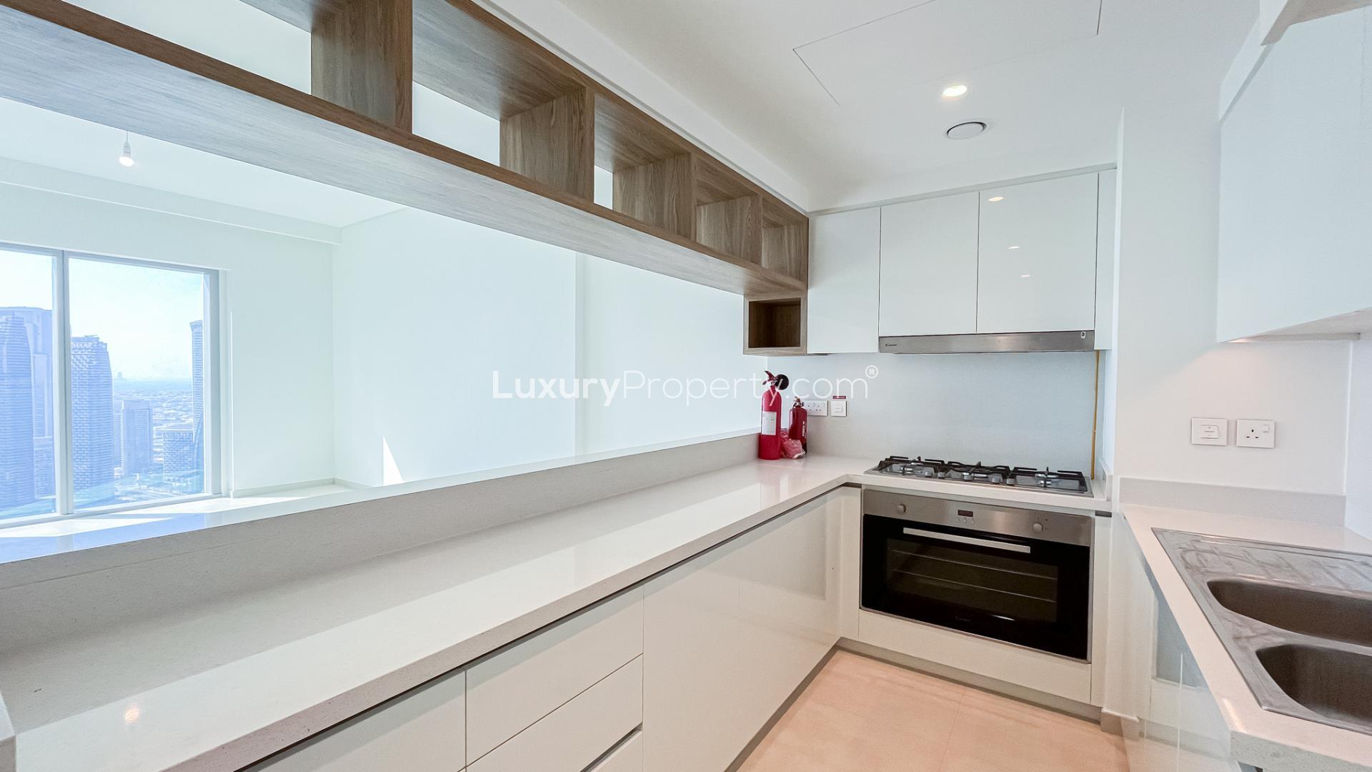 Empty living room with large windows in Downtown Views II apartment, Dubai