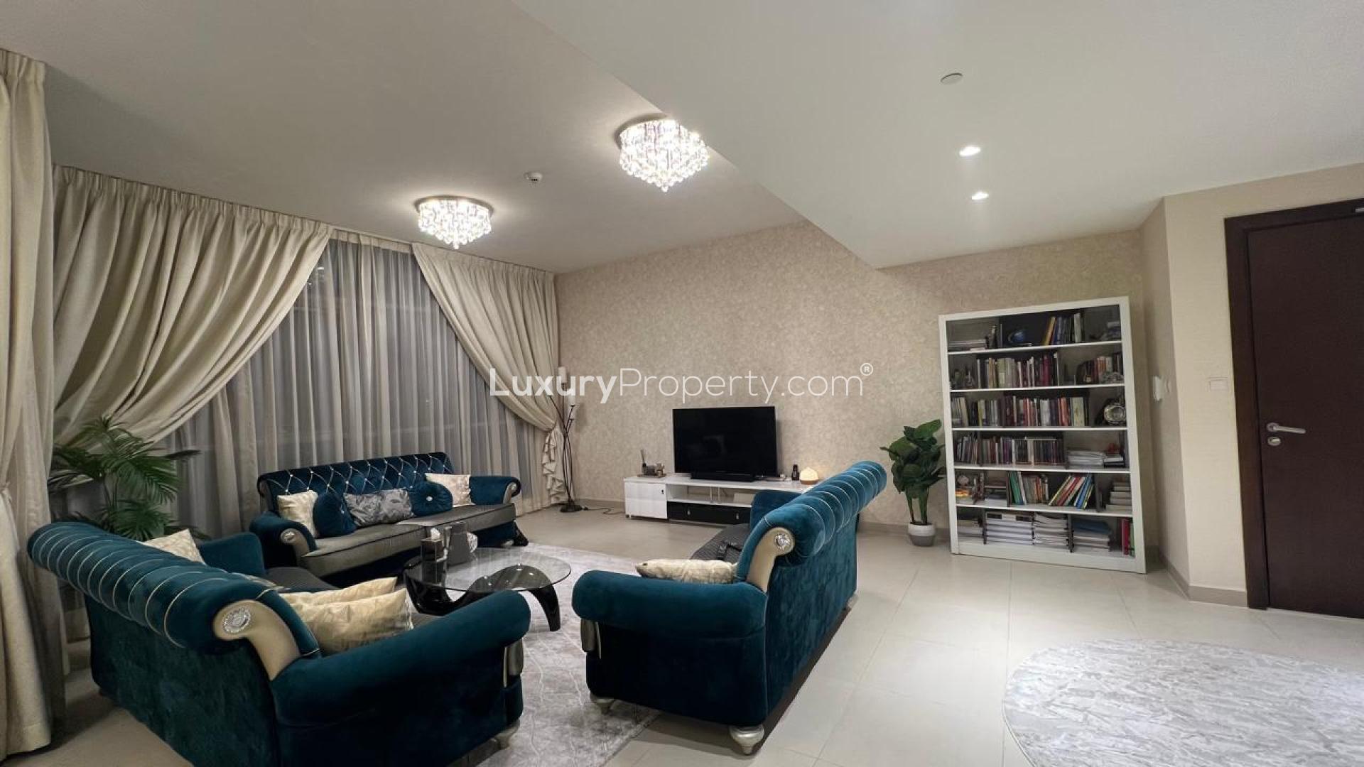 Corner unit apartment living room with modern decor, large windows, and park view in Dubai Hills
