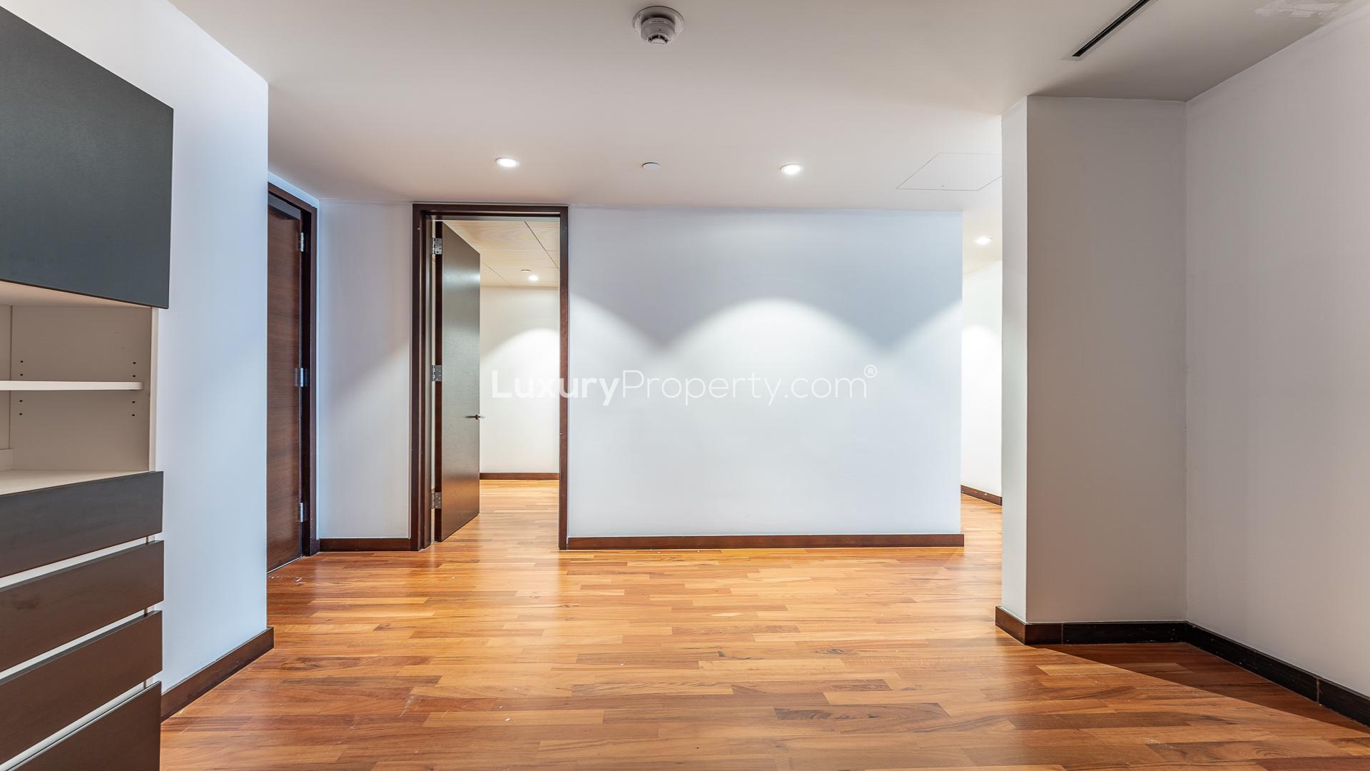 Empty apartment with panoramic city views through large windows in Burj Khalifa