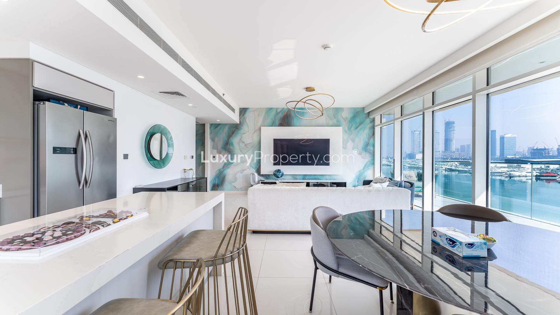 Furnished living room with city skyline view in Sunrise Bay apartment, Emaar Beach Front, Dubai