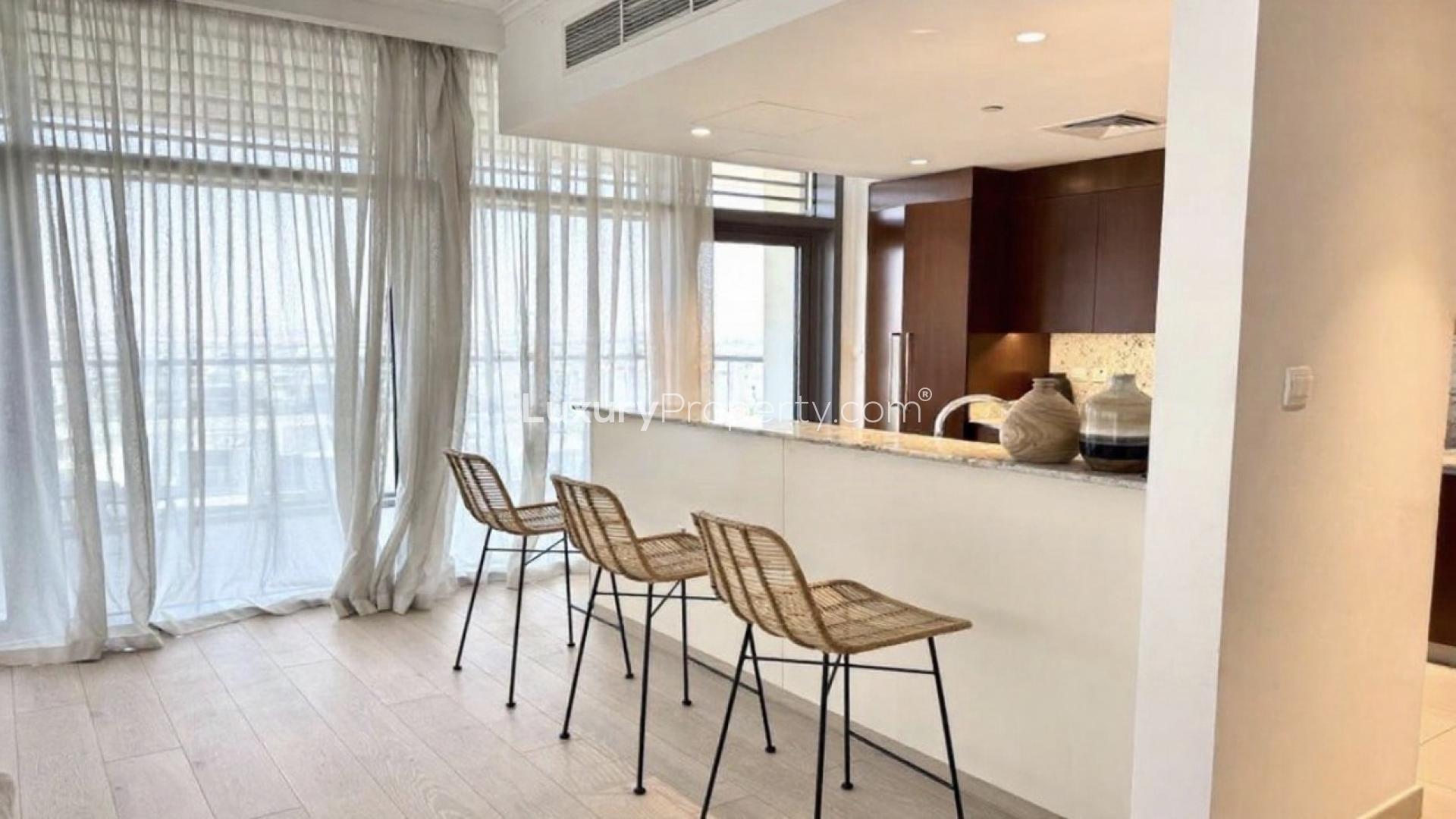 Furnished living room with large windows in Dubai Hills Estate apartment for rent