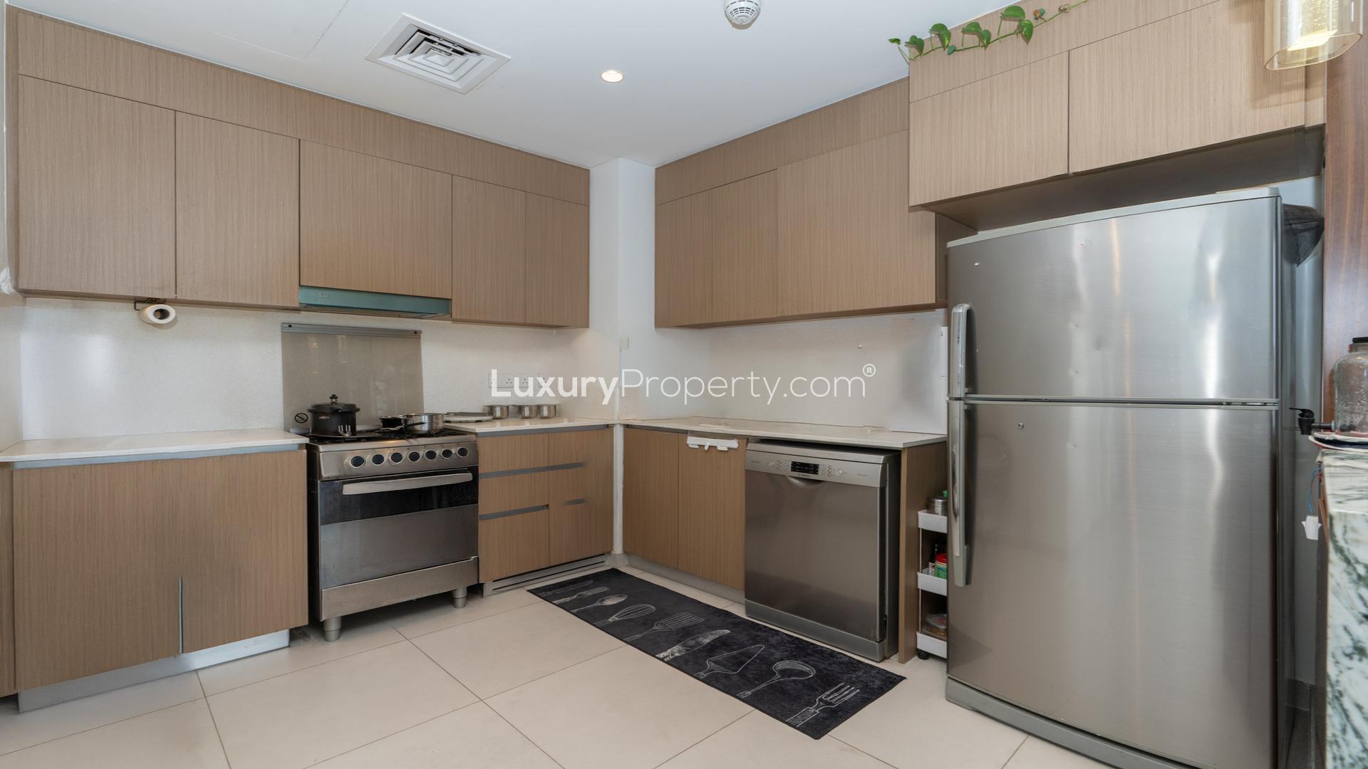 Modern living room in high-floor Dubai Creek Harbour apartment, featuring stylish furniture and decor