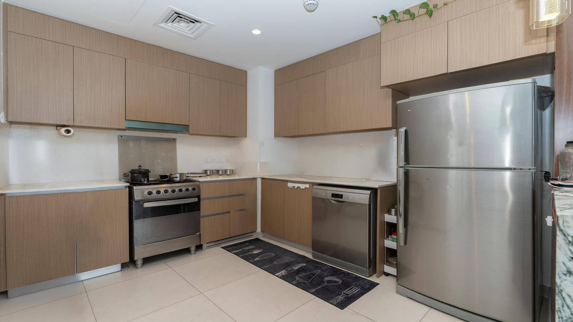 Modern living room in high-floor Dubai Creek Harbour apartment, featuring stylish furniture and decor