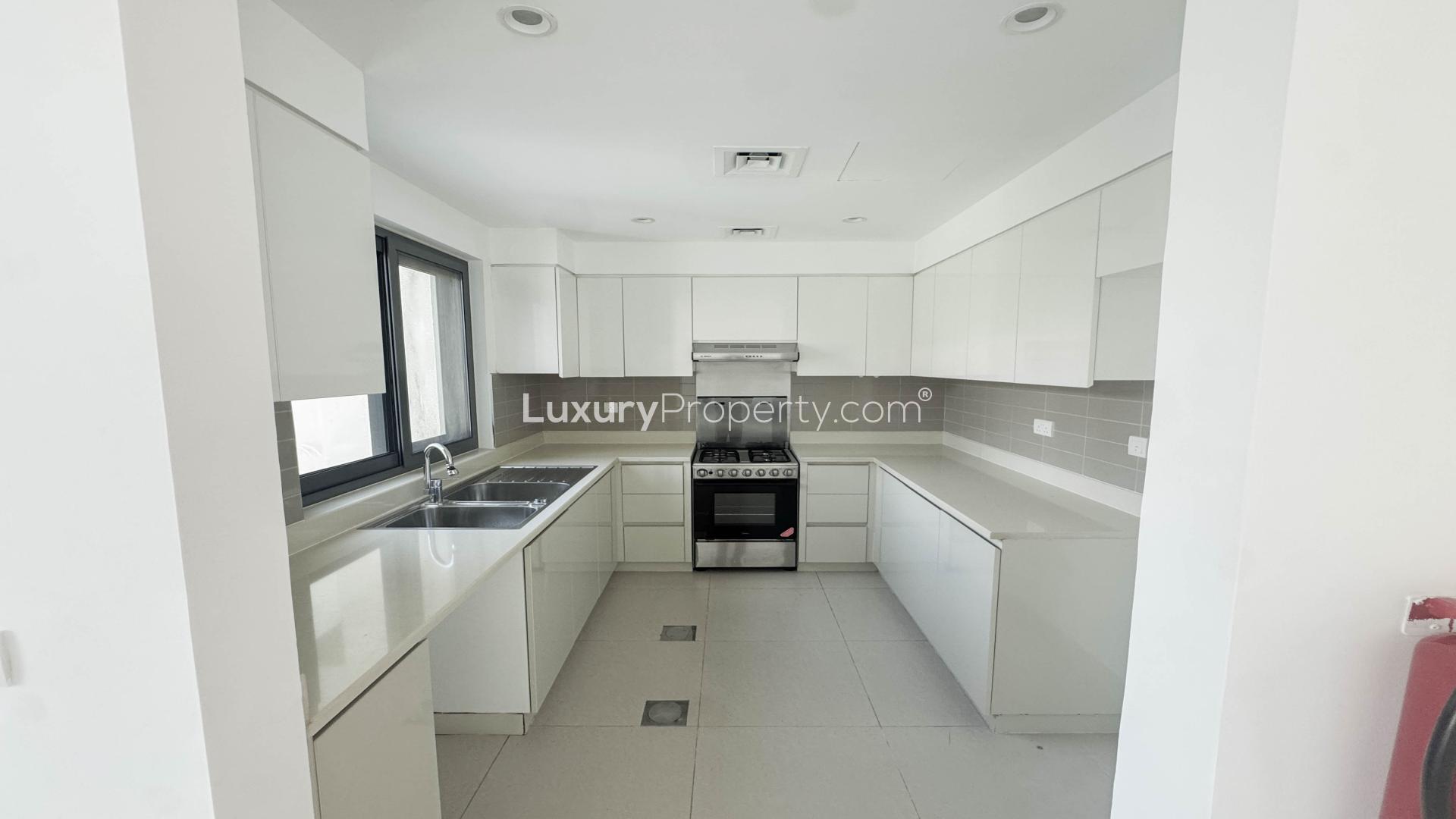 Bright, spacious living room with garden view in Dubai Hills Estate apartment for rent