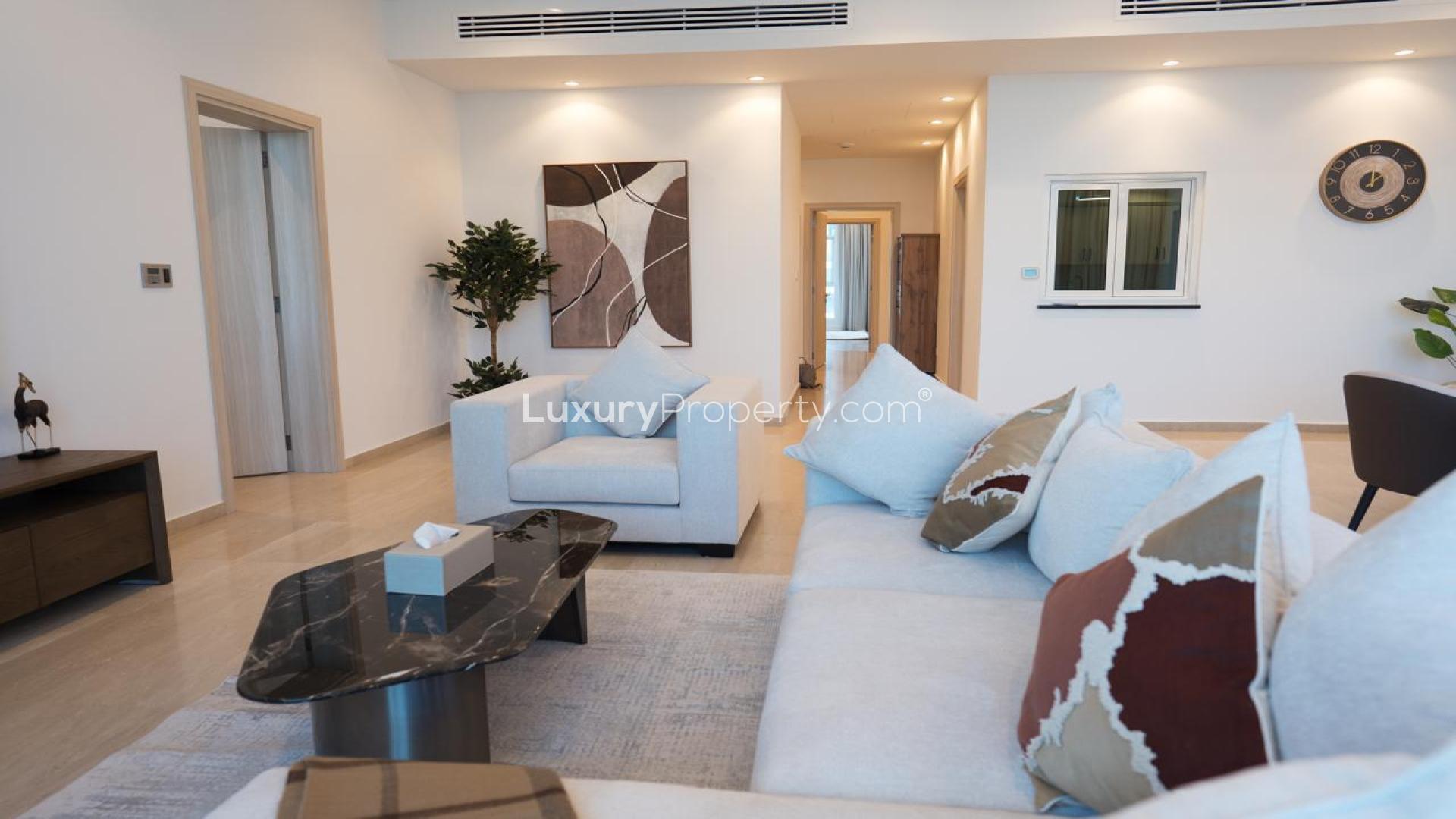 Modern living room in Palm Jumeirah apartment with water view, featuring elegant dining area