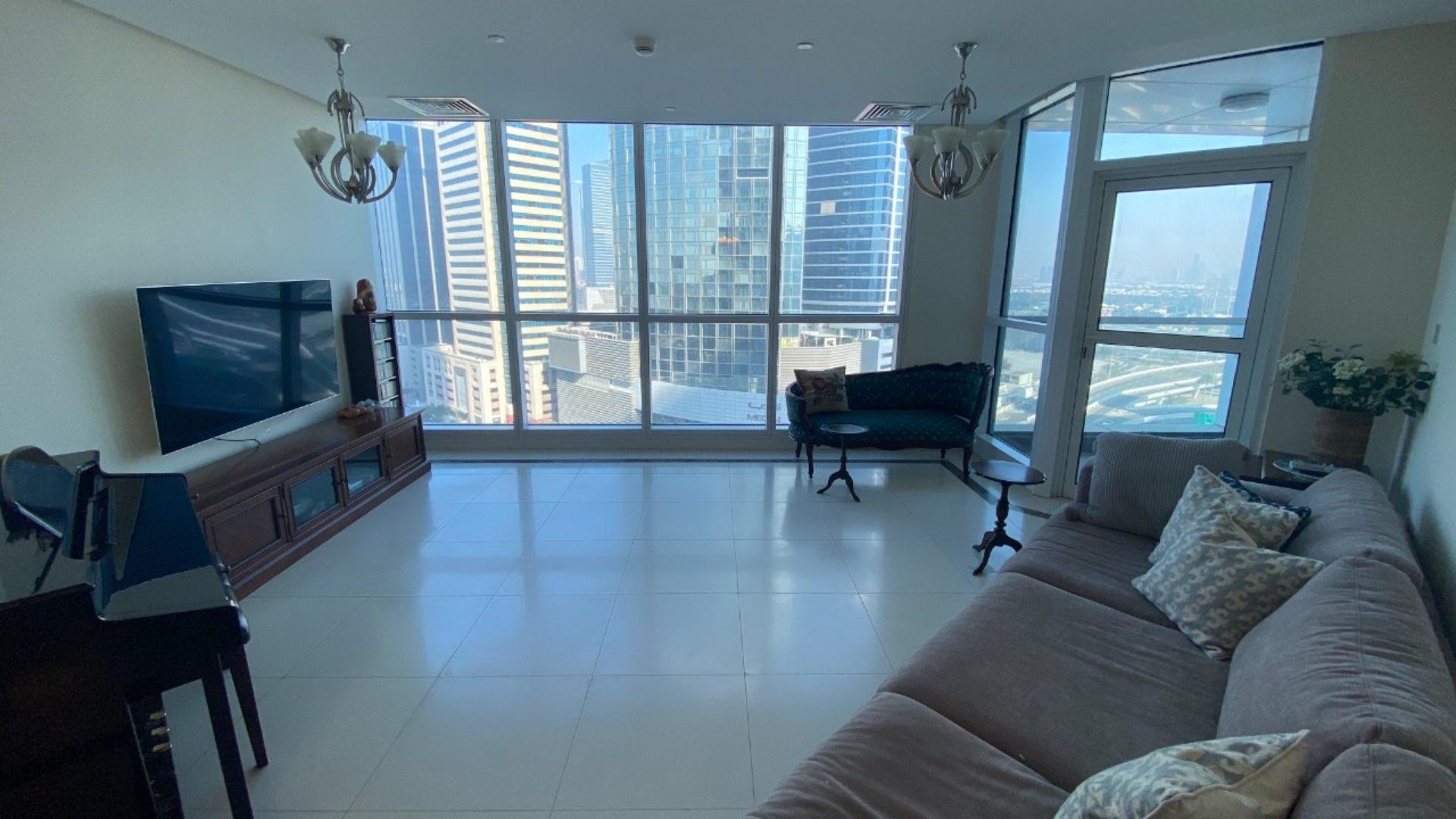 Dining area in 3-bedroom apartment, 23 Marina, Dubai Marina. Elegant wooden table, cozy decor
