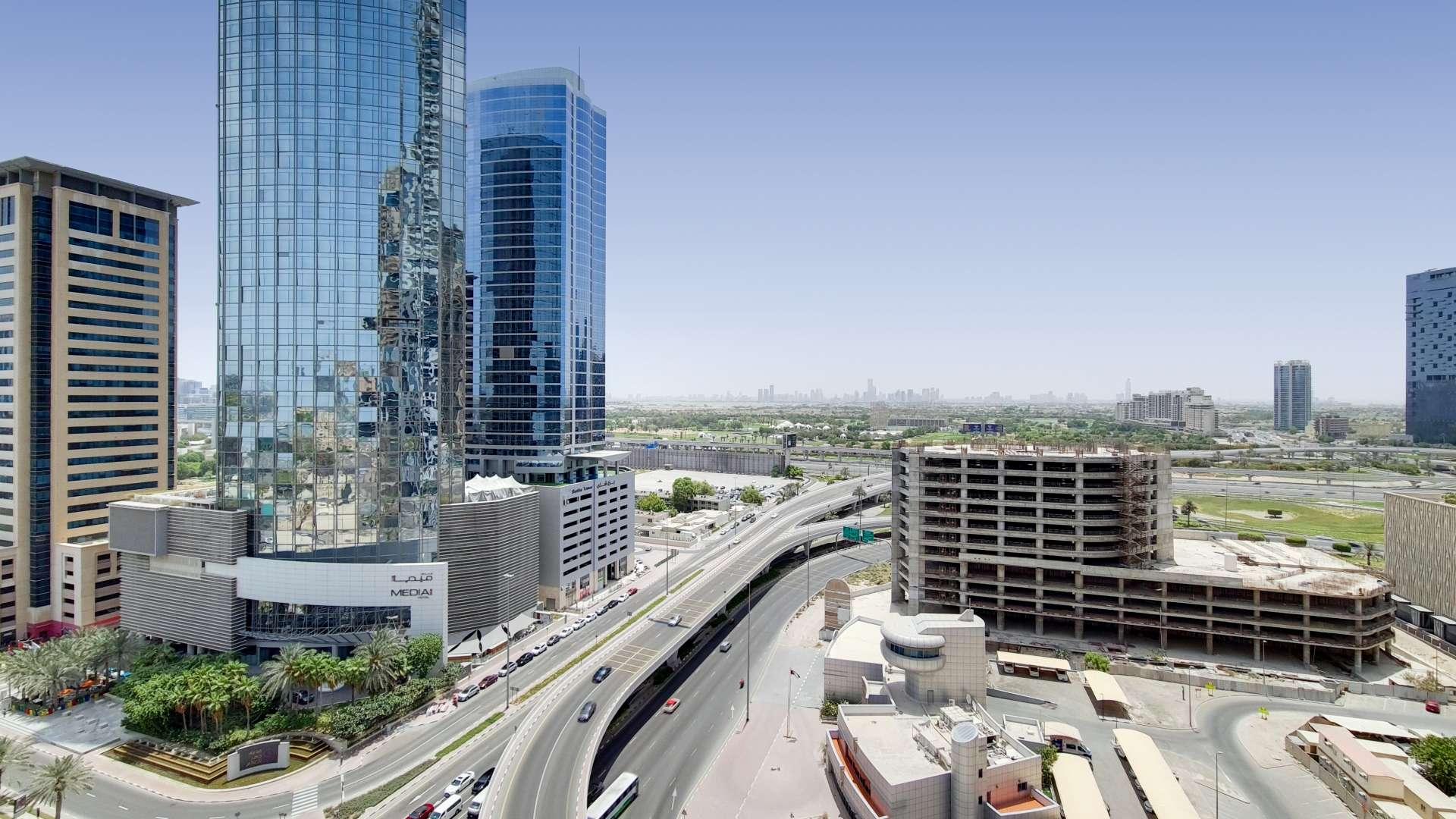 Contemporary bedroom in Dubai Marina apartment with skyline view, modern furnishings, and large windows