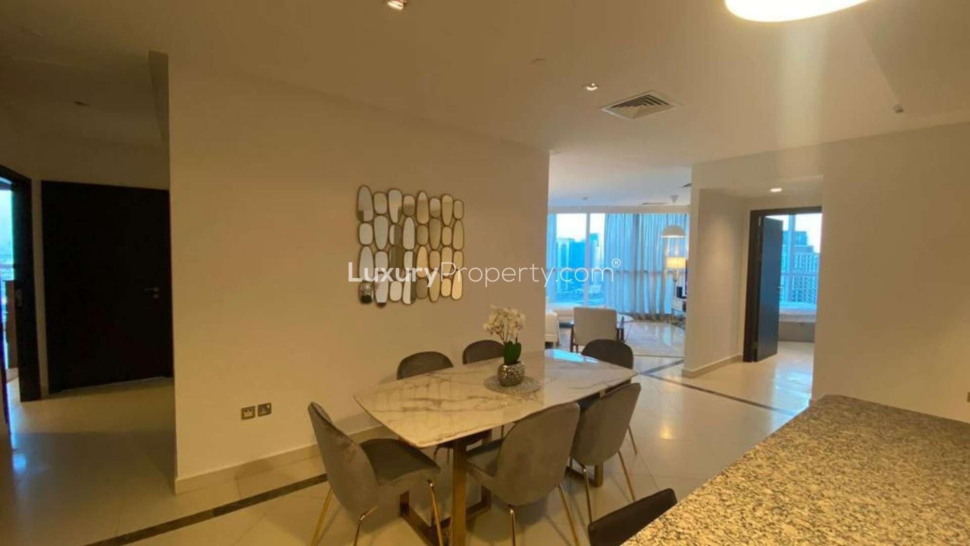 Furnished living room with large windows, modern decor, and city views in 23 Marina, Dubai Marina