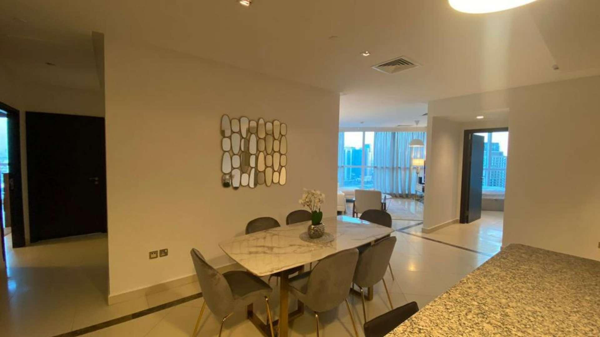 Furnished living room with large windows, modern decor, and city views in 23 Marina, Dubai Marina