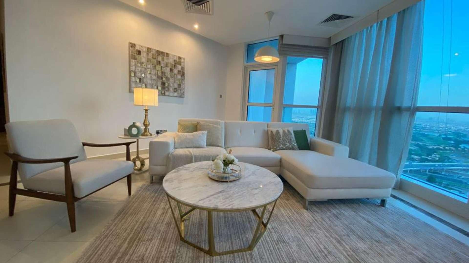 Furnished living room with city views in 3-bedroom Dubai Marina apartment for rent