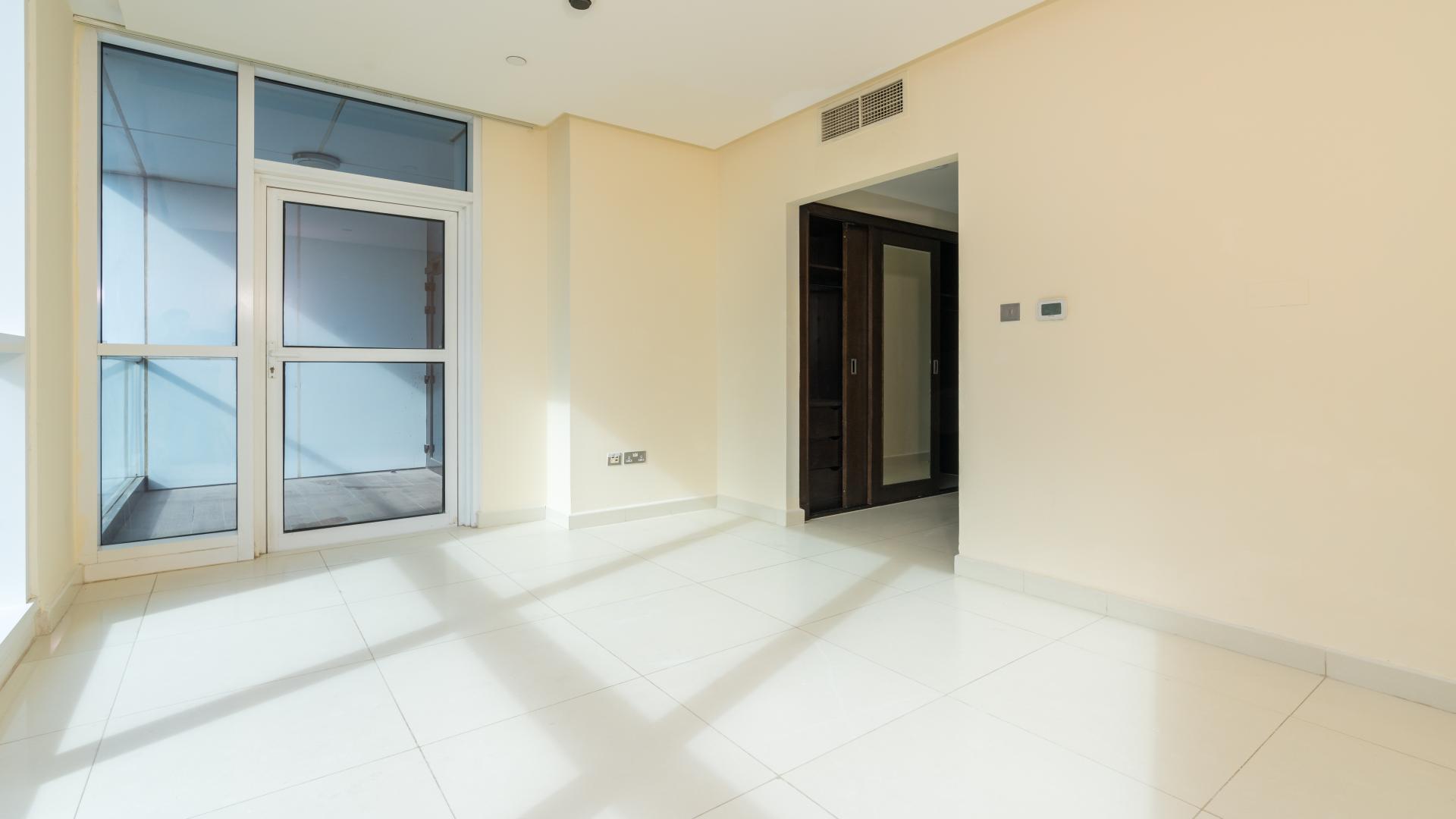 Spacious walk-in closet with wooden finish in 3-bedroom apartment, 23 Marina, Dubai Marina