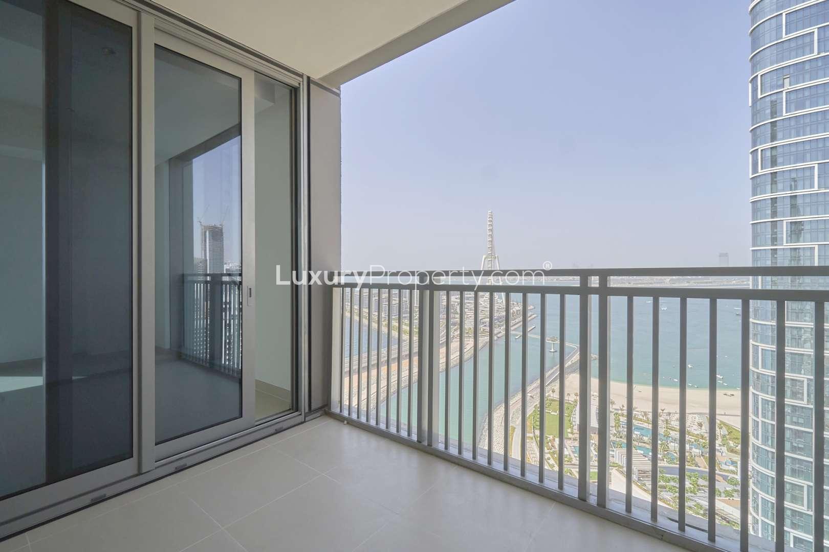 Empty room with tiled floor, large window, and balcony view in Dubai Marina apartment