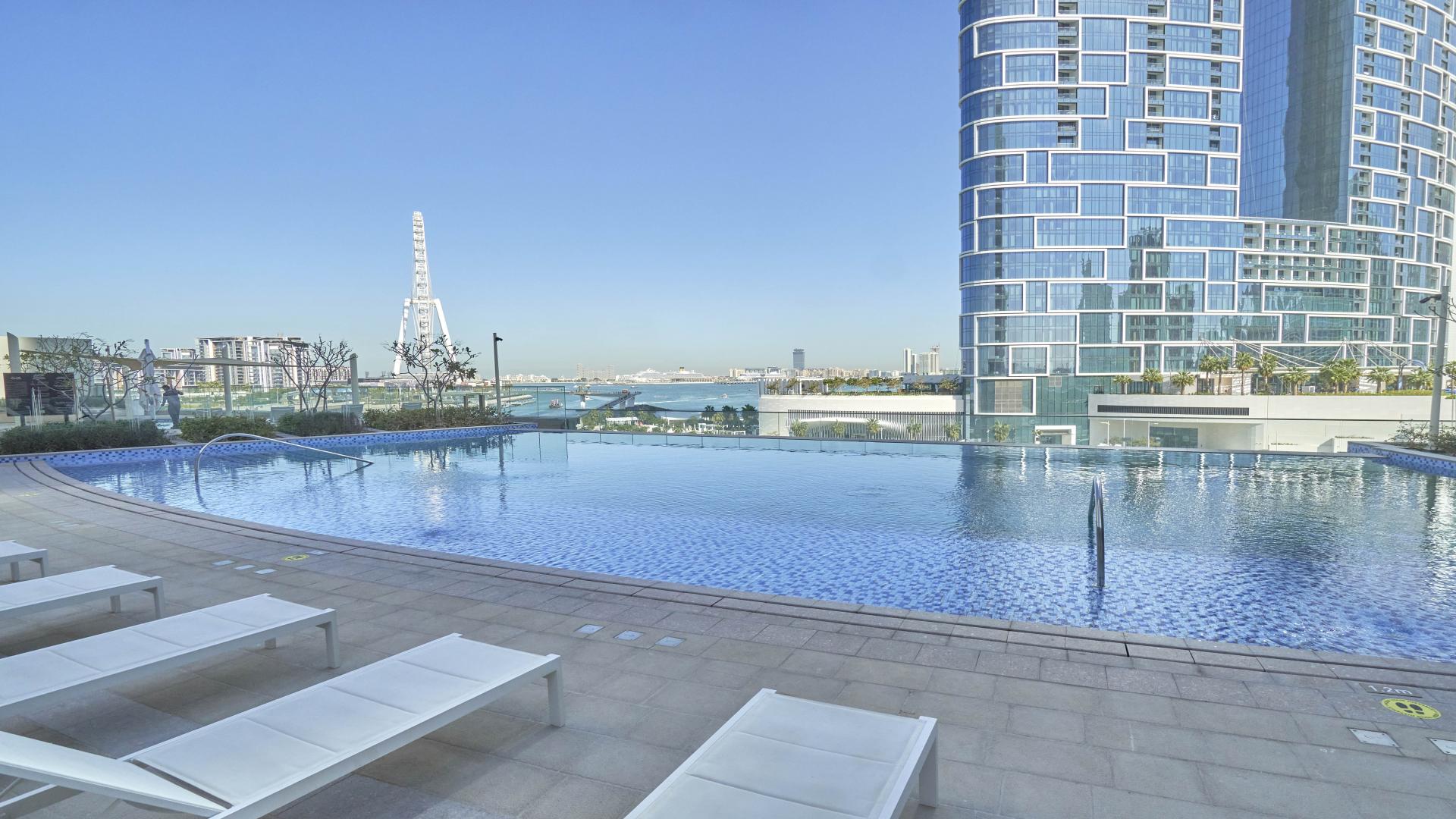 "Balcony view of Ain Dubai and sea from Marina apartment in 5242, Dubai Marina.",Infinity pool with Ain Dubai view at luxury Marina apartment in 5242, Dubai Marina
