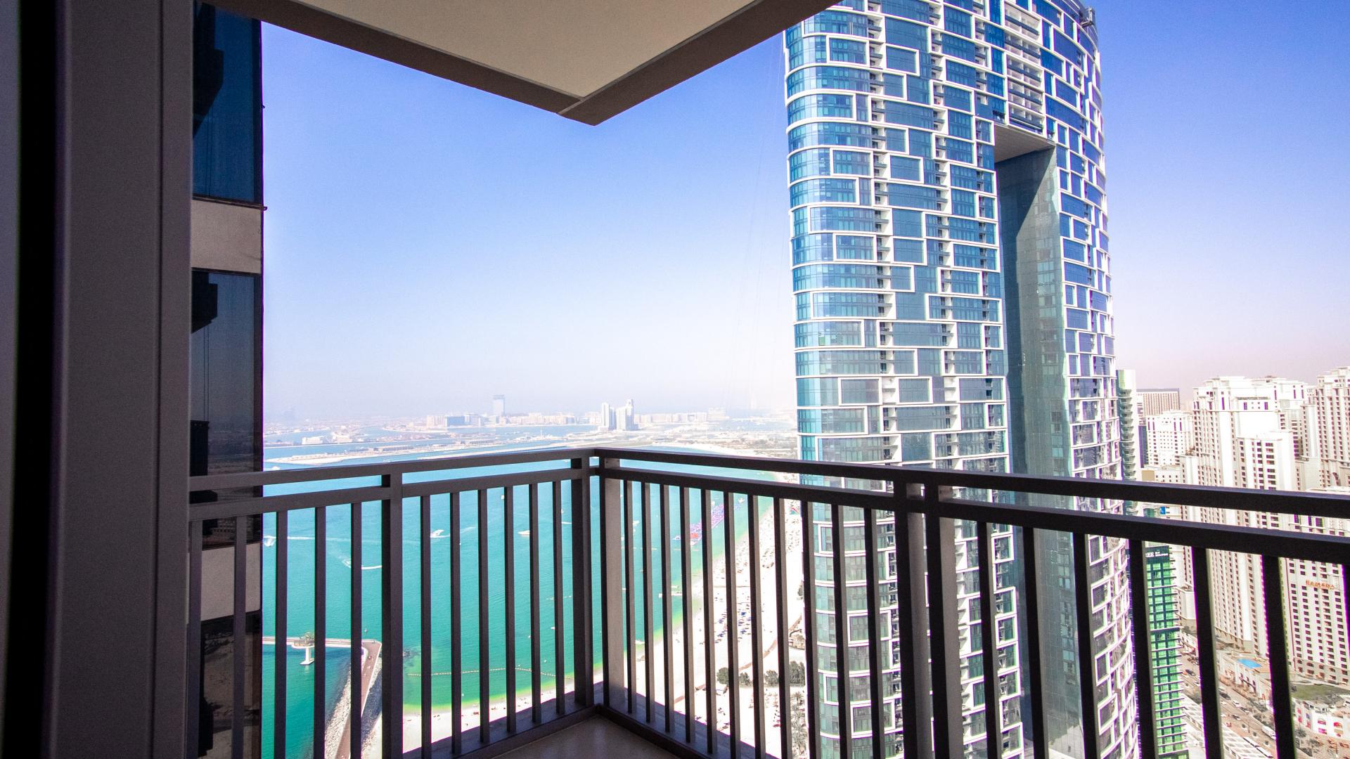 Spacious Dubai Marina apartment interior with sea view, modern kitchen, large windows