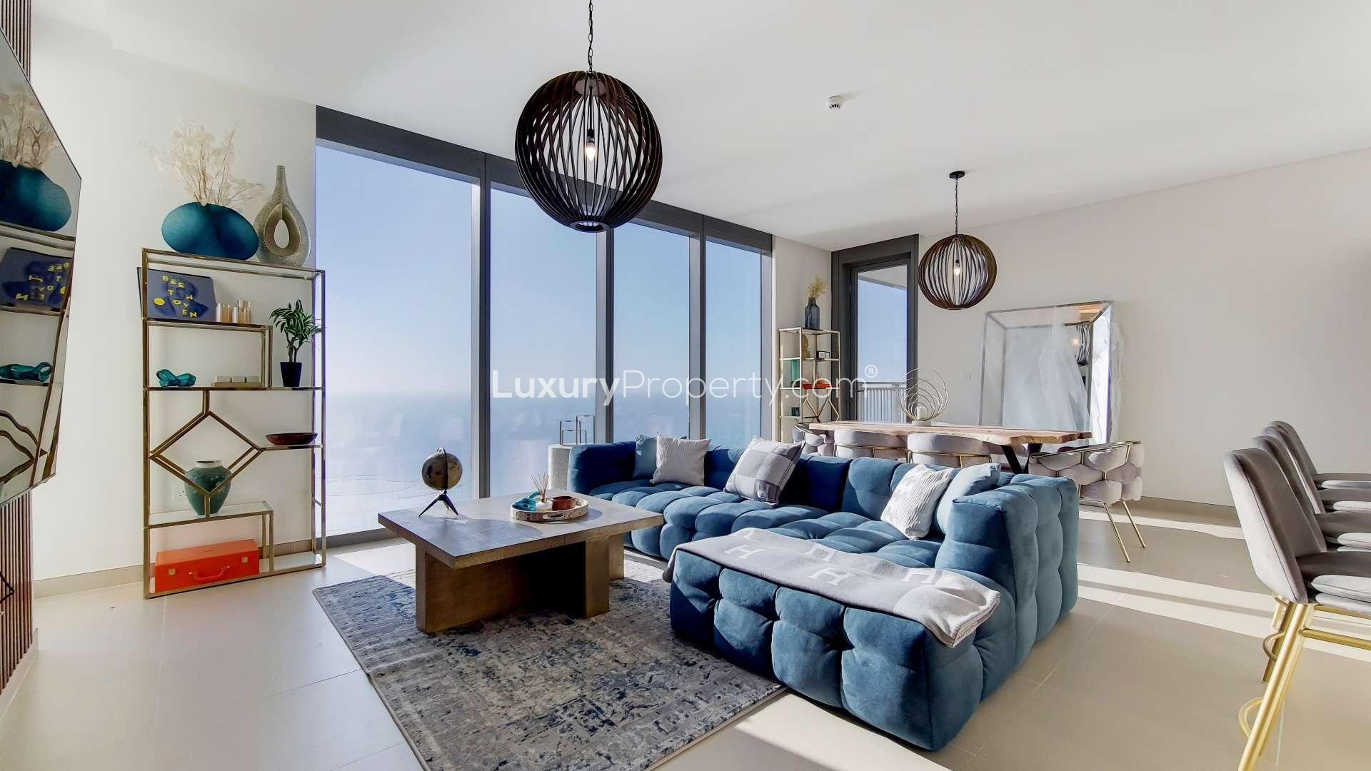 Spacious Dubai Marina apartment living room with sea views, modern decor, and large windows