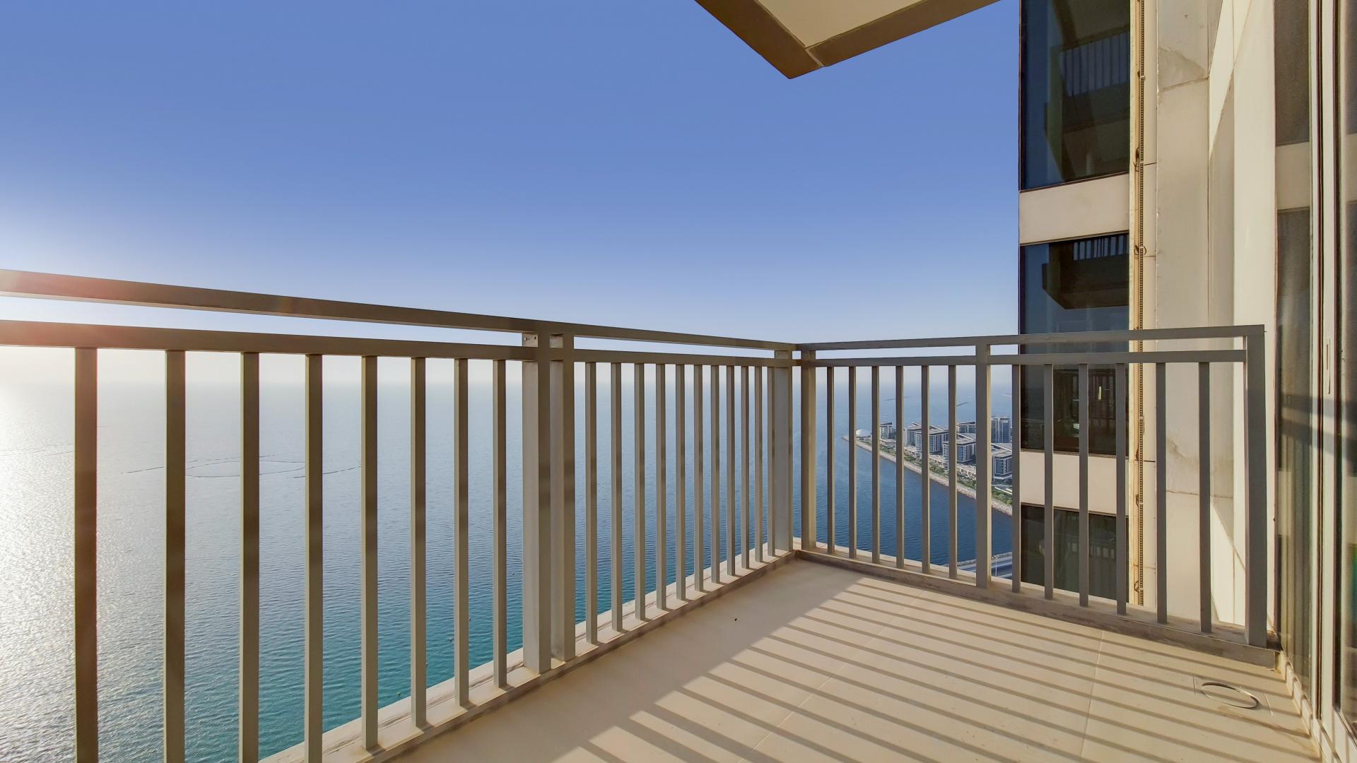 Spacious Dubai Marina apartment living room with modern decor and large windows offering views