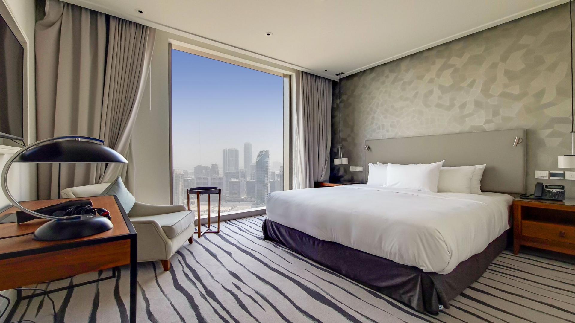 Modern dining and living area in stylish Downtown Vida apartment, Dubai skyline view