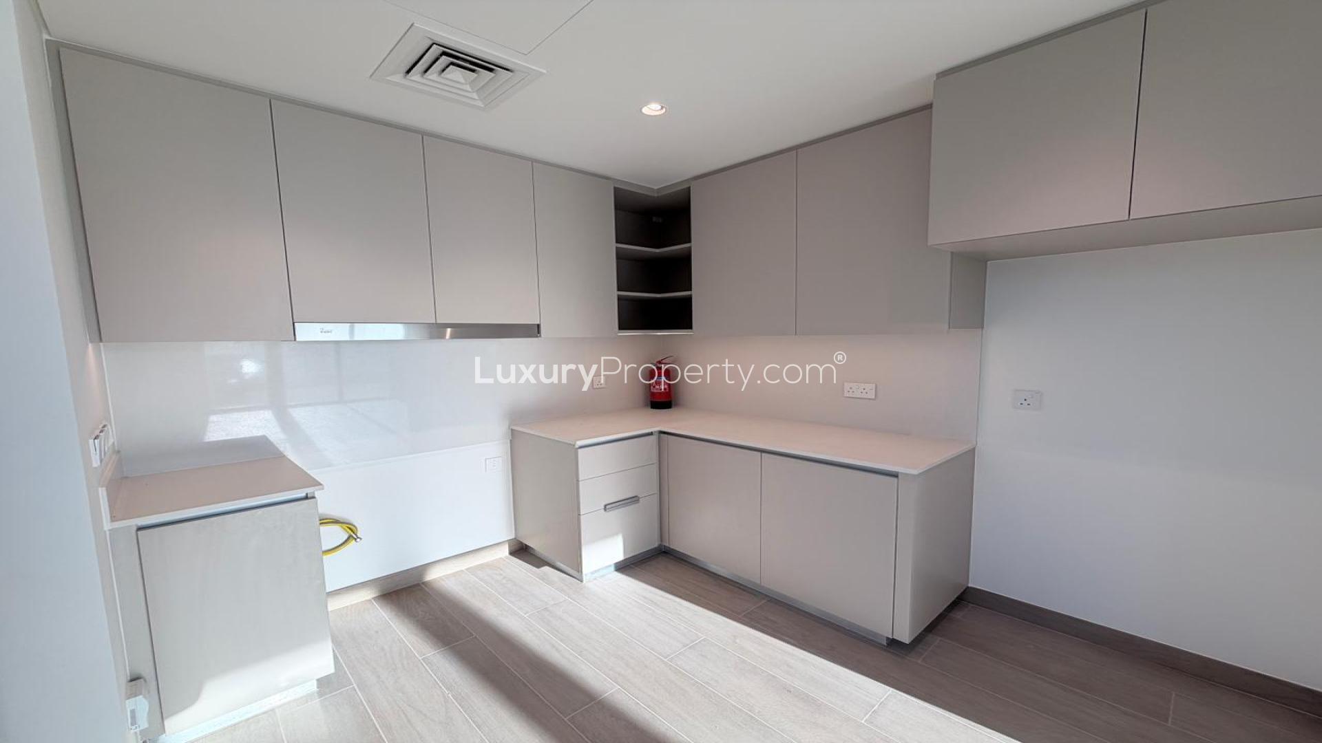 Apartment view at Dubai Creek Harbour, Grove at Creek Beach, with palm-lined pathways