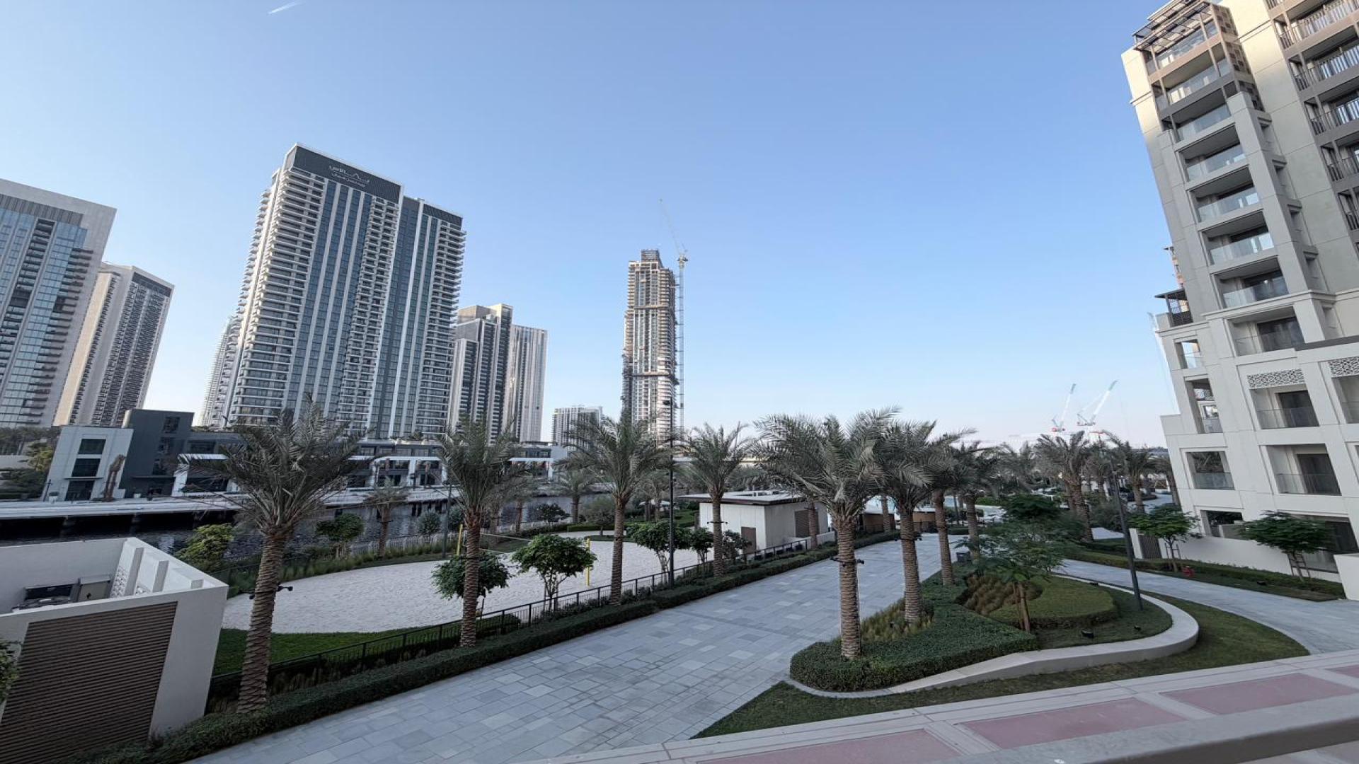 Spacious living room with large windows in Dubai Creek Harbour apartment for rent