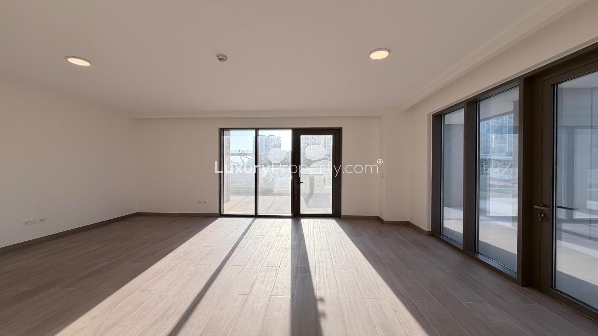 Spacious living room in Dubai Creek Harbour apartment, large windows, modern design, natural light