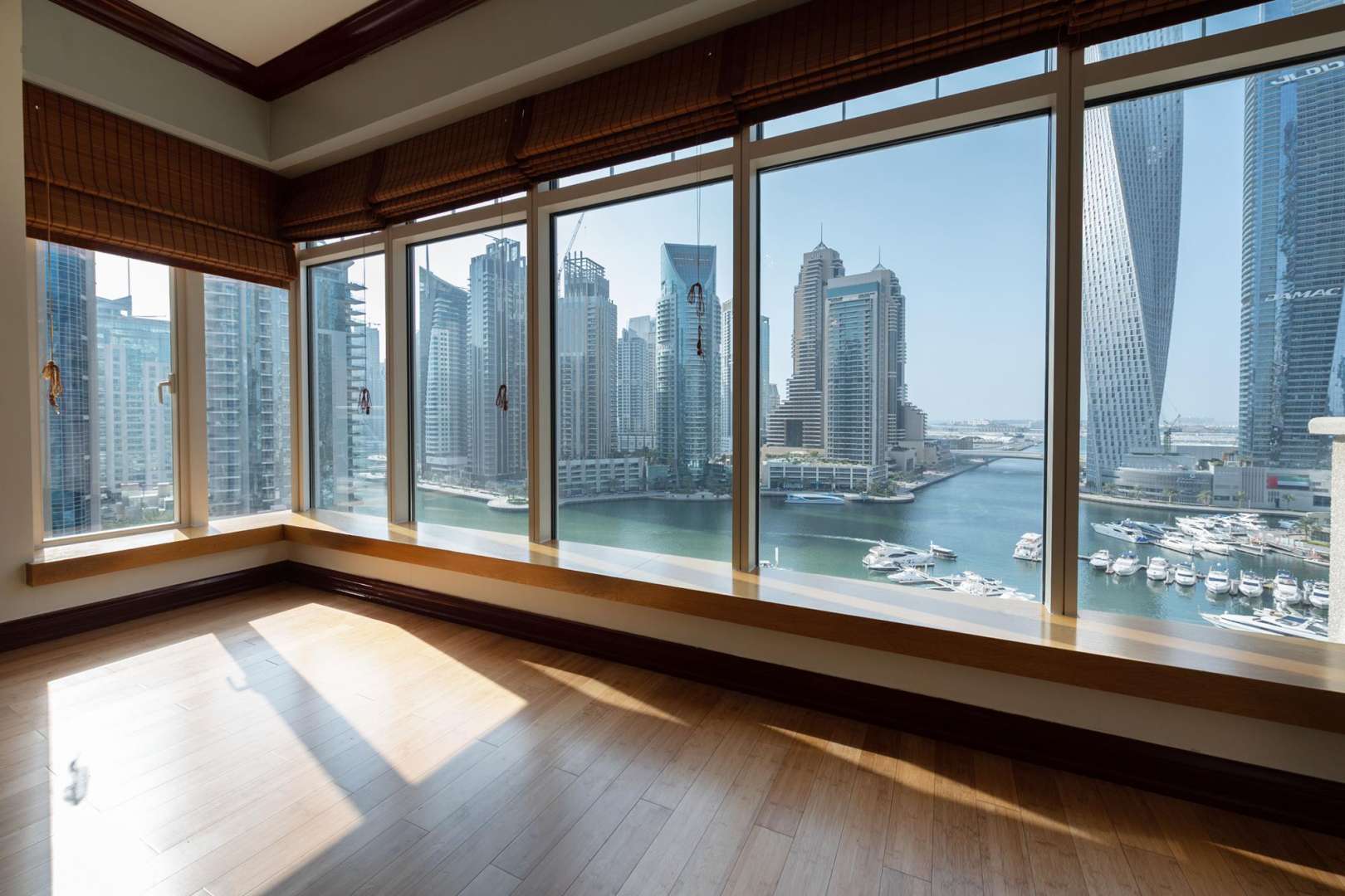 Spacious living room with large windows and Dubai Marina view in Al Anbar Tower apartment