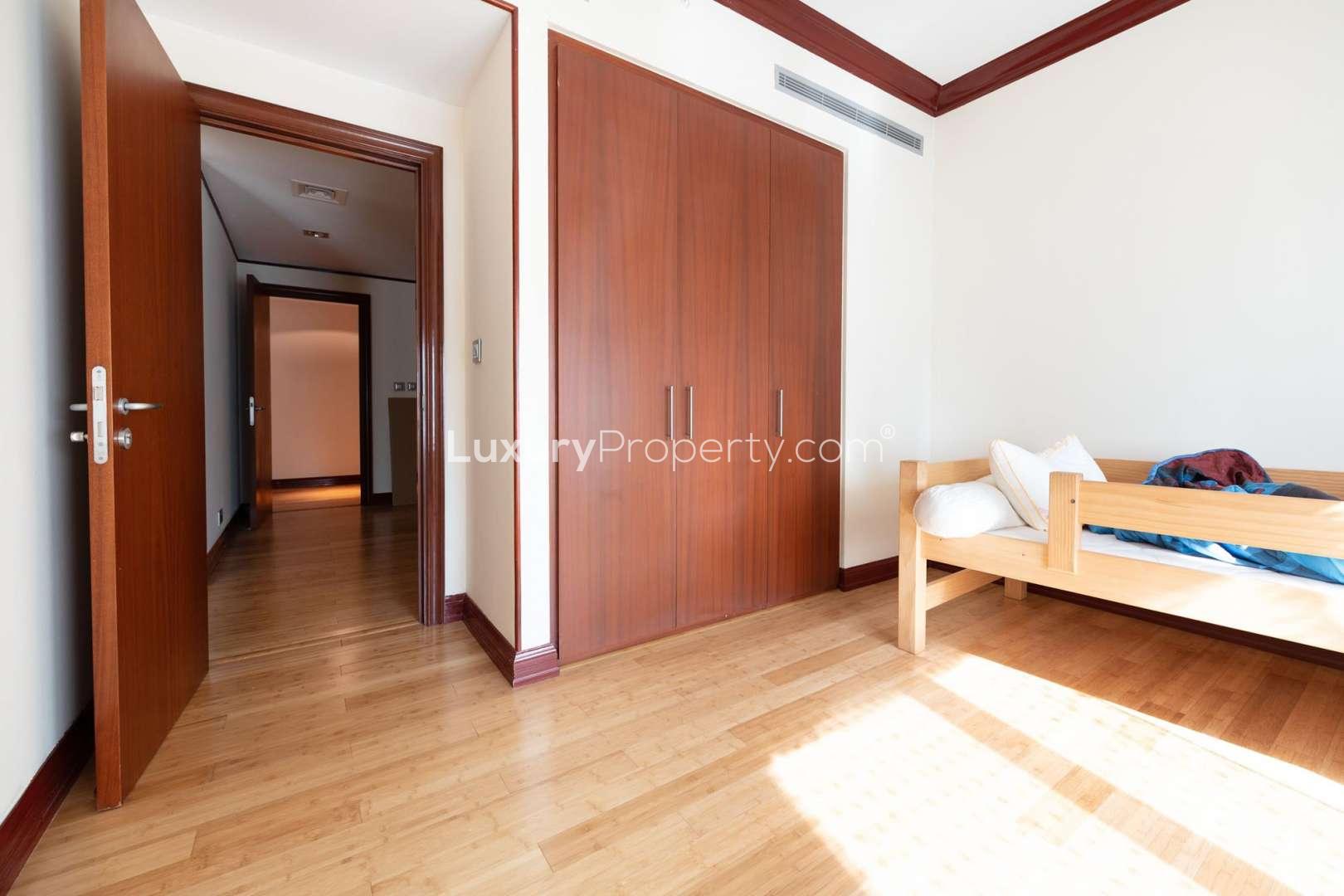Empty bedroom with wooden flooring and built-in wardrobe in Al Anbar, Dubai Marina apartment