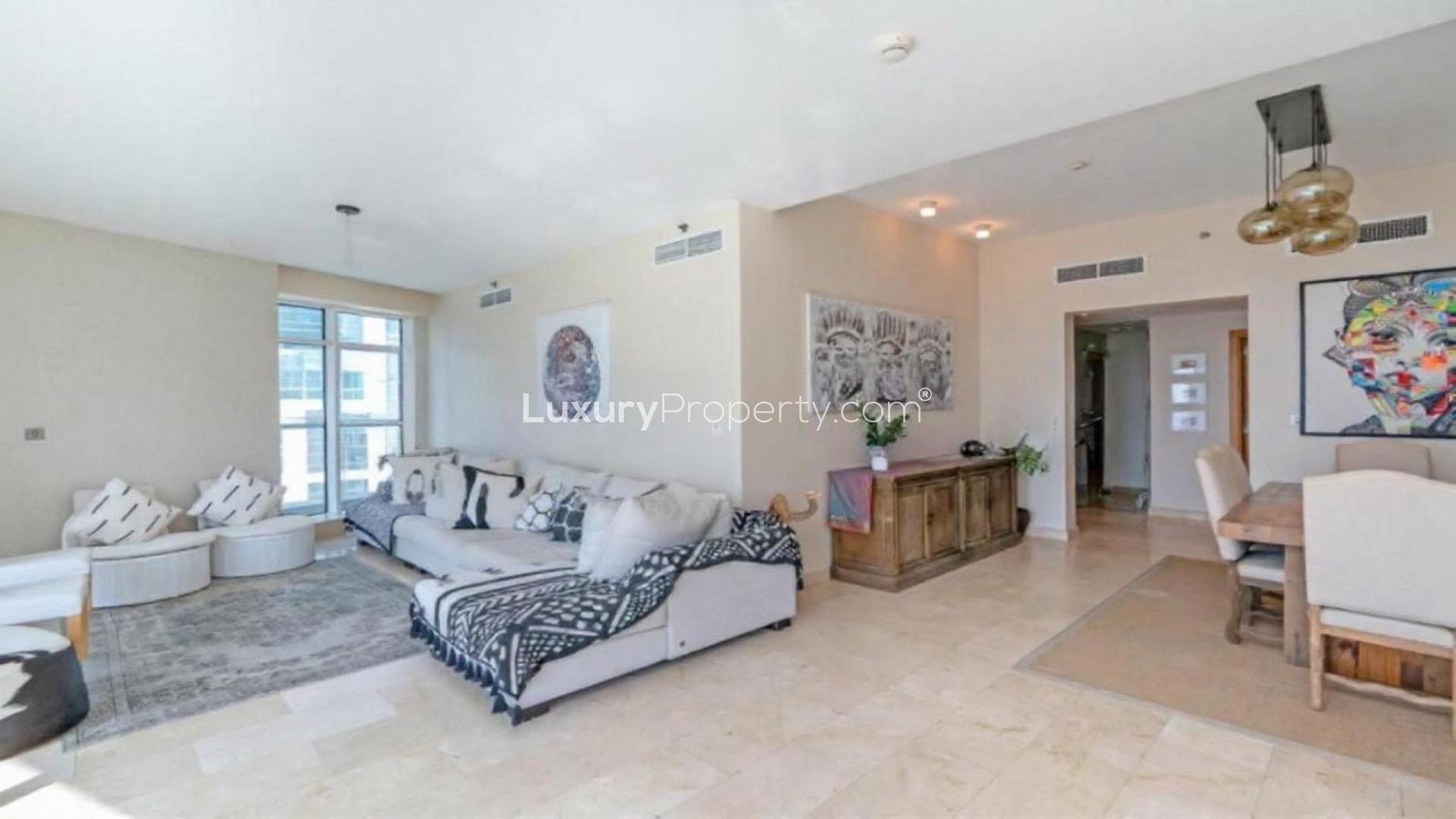 Bright living room with panoramic windows in Trident Bayside apartment, Dubai Marina