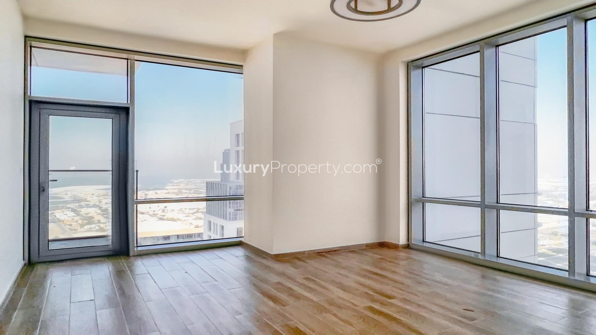 Spacious living room with large windows, high floor canal view, Al Habtoor City apartment