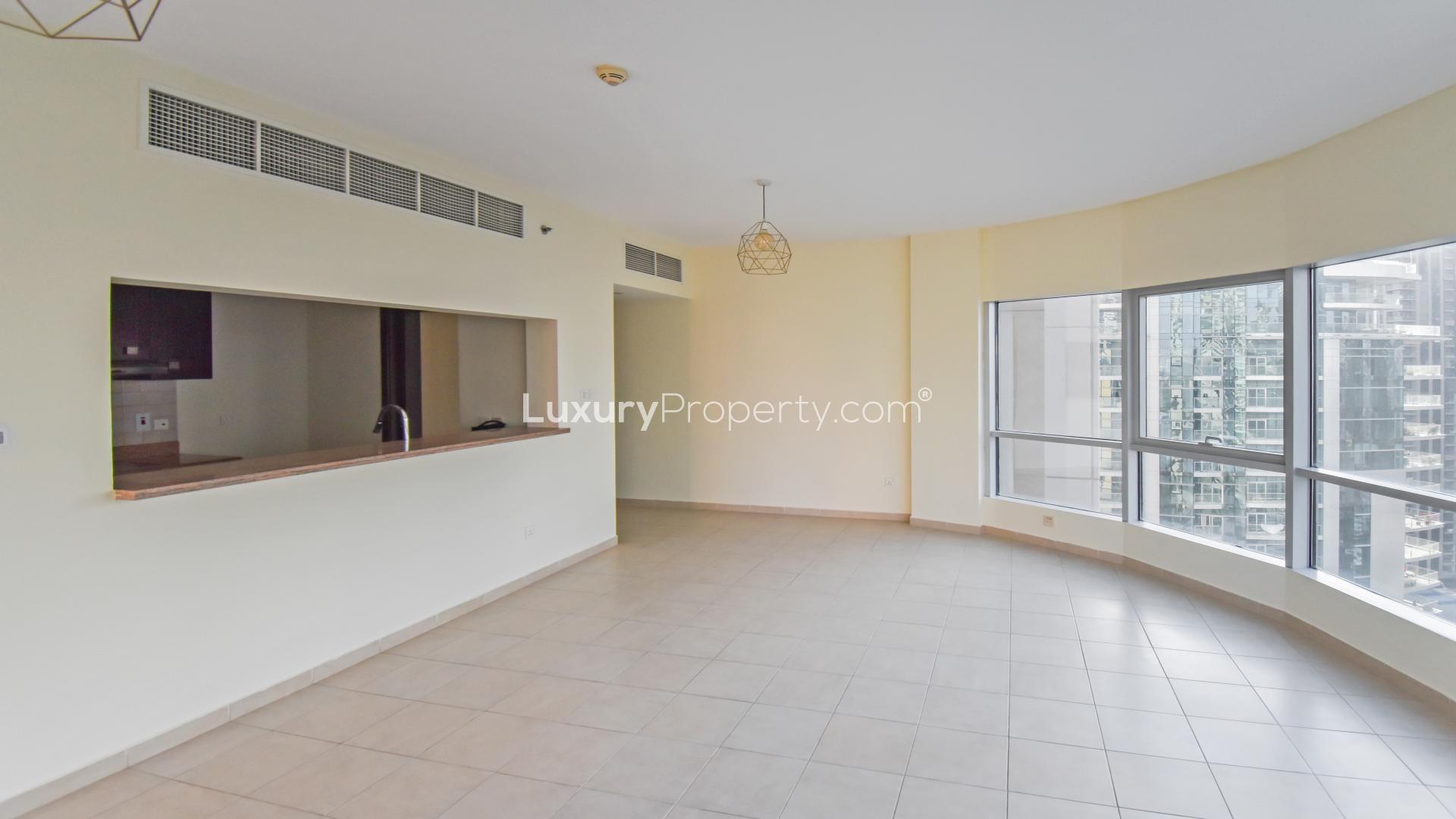 Spacious living room with large windows in Al Habtoor Tower, Business Bay apartment for rent