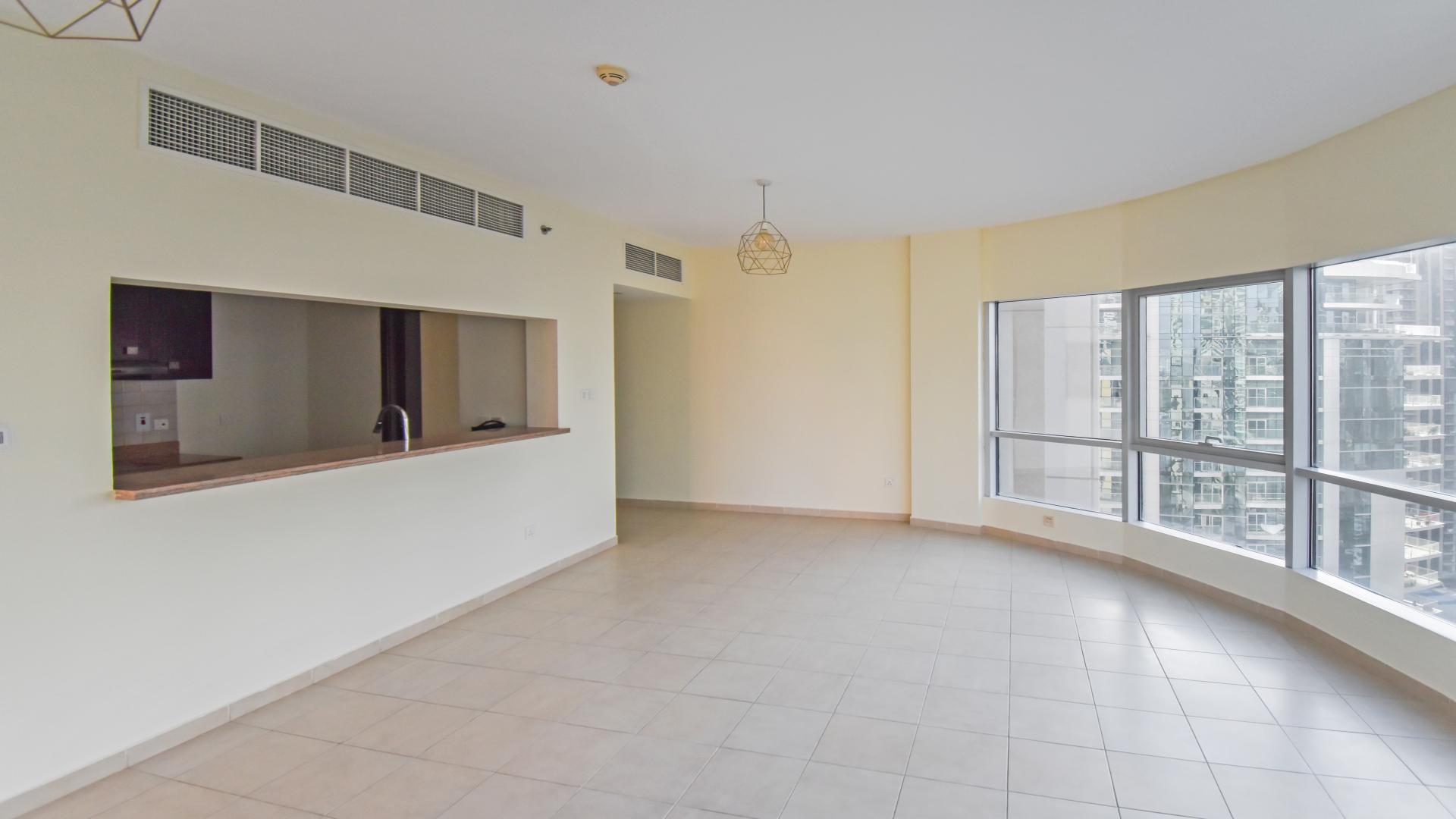 Spacious living room with large windows in Al Habtoor Tower, Business Bay apartment for rent