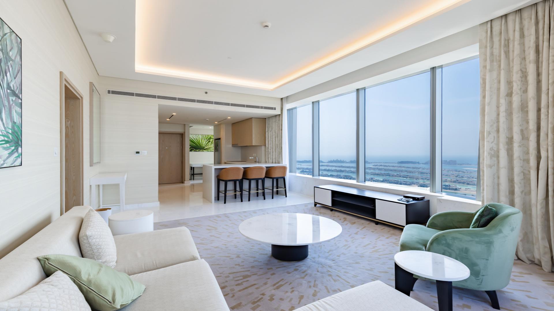 Luxurious Palm Jumeirah apartment living room with ocean view, modern decor, and natural light